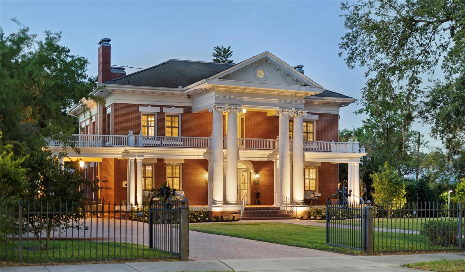 Luxury home for sale in Florida, historic estate with pool, guest suite and over 5,200 square feet. Central Florida real estate, this one-of-a-kind Florida luxury home for sale is a rare opportunity to own an exceptional, fully renovated historic estate offering over 5,200 square feet of living space on a private, landscaped lot in the heart of Central Florida. Built in 1925 and thoughtfully restored to preserve its original character, this timeless residence combines historic charm with modern luxury — ideal for buyers searching for unique Florida homes, luxury real estate or historic houses for sale in Florida. From the moment you arrive, the curb appeal is undeniable, a grand red brick exterior, stately white columns and a sweeping front porch welcome you to this Southern-style estate home. Inside, the home offers original hardwood flooring, four working fireplaces, plaster ceilings, elaborate millwork, designer chandeliers, and spacious formal living and dining areas that are ideal for entertaining. The chef’s kitchen has been upgraded with marble countertops, custom Kraftmaid cabinetry and professional-grade Viking appliances. Adjacent to the kitchen is a sunroom and a beautifully finished laundry/mudroom that leads directly to the outdoor living space. The main level also includes a bright formal living room, elegant dining room, and bonus spaces for an office or family room. Upstairs, the luxurious primary suite includes a fireplace, spa-style bath with a clawfoot soaking tub, frameless glass walk-in shower and a custom dressing room. Additional guest bedrooms each have en-suite baths with modern finishes. The third floor offers a private guest suite complete with a kitchenette, full bat, and a cozy sitting area, ideal for multigenerational living, visitors or even short-term rental potential. Outside, enjoy your Florida backyard oasis with a heated saltwater pool, fountains, a covered entertaining pavilion, a gourmet outdoor summer kitchen, cooling misters and ceiling fans — everything designed for year-round outdoor living in the Florida climate. The fully fenced, professionally landscaped yard creates a private estate setting that’s rarely found in non-waterfront Florida homes. This Florida home for sale is in a non-flood zone with no HOA and offers a detached two-car garage with a workshop and additional parking. With its unmatched combination of space, style, location and character, this estate is ideal for those seeking luxury homes in Florida, homes for sale near Orlando, or Central Florida homes with acreage and privacy. Positioned just minutes from shopping, dining, and top-rated schools, and within easy reach of Tampa and Orlando, this property offers a balance of convenience and serenity. Whether you’re relocating, investing or upgrading, this home is a standout among Florida homes for sale, estate homes and historic real estate listings. Don’t miss this rare opportunity to own a Florida landmark with the features today’s buyers demand — luxury finishes, space to live and entertain, and timeless architectural detail. Schedule your private tour today!