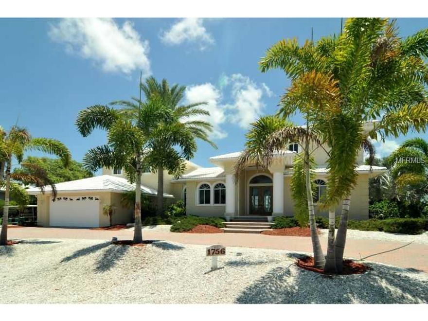 Enjoy exquisite bay views from almost every inch of this 4 bedroom 7 bath home located in desirable Boca Grande Isles.  This well built concrete home with pool has high ceilings, 2 fireplaces and a custom boat dock with two lifts.  This is a beautiful waterfront home priced to facilitate remodeling should you desire.  Seller has excellent plans and renderings available.
