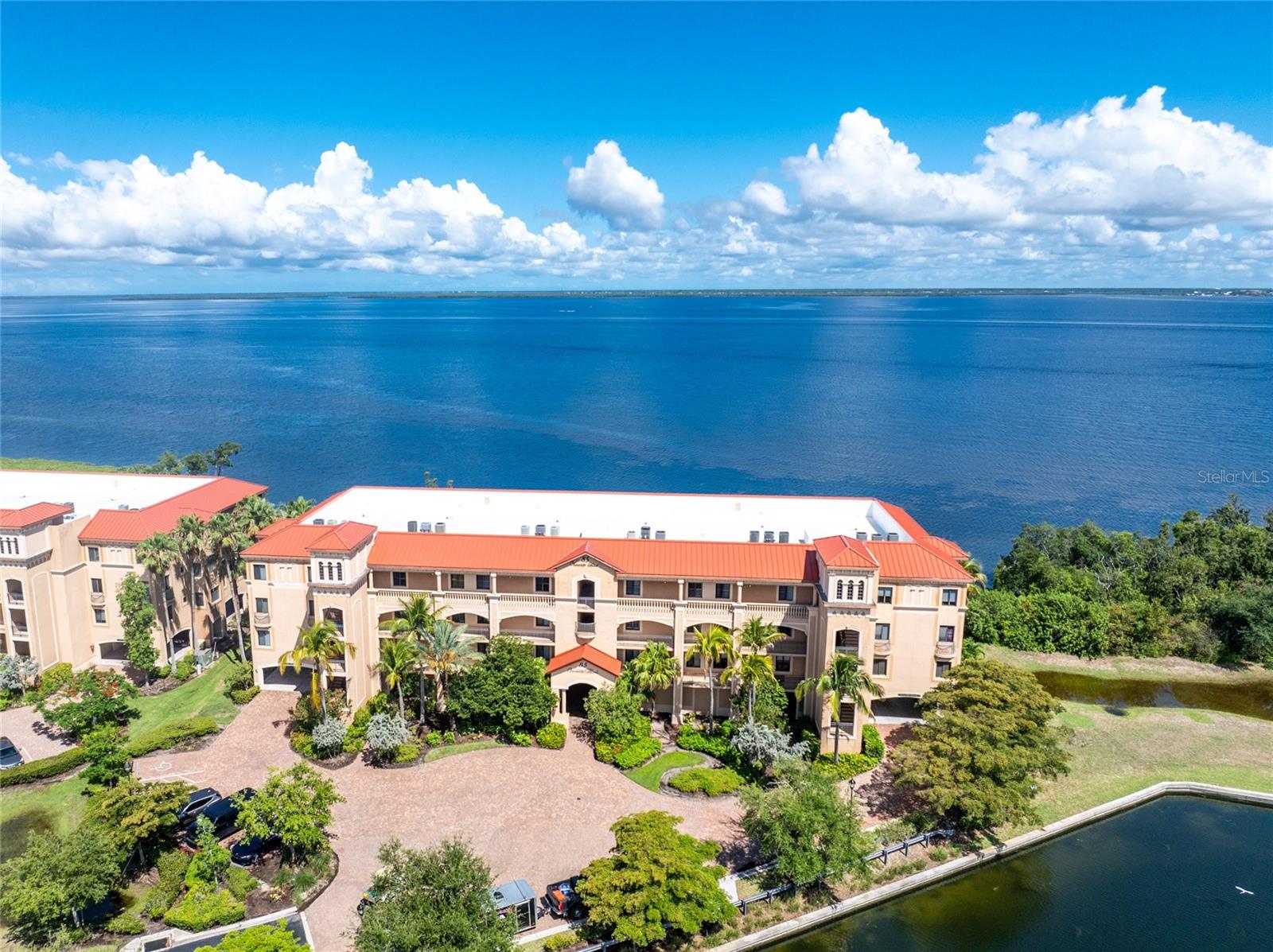 One or more photo(s) has been virtually staged. Picturesque water views of the Charlotte Harbor connected with Luxury living in beautiful Bella Lago Vivante, a gated community that offers all the amenities of resort style living. Come see this Beautifully updated condo that offers 2338sf, split floor plan, 3 bedroom, 3 full bathrooms with assigned under building parking with EV power hookup, and a private elevator that takes you directly into the home. With High ceilings, LVP flooring throughout most of the home, fresh paint, granite counters, white cabinets, newer stainless kitchen appliances, newer washer and dryer, this home is stunning! The updated master bathroom has a newly configured floorplan and boasts new cabinets, quartz counters, flooring, a large walk-in shower and water closet. The Master bedroom has 2 walk-in closets, access to the lanai and amazing views of the harbor. The Great room has sliders out to oversized lanai, interior electronic shade screens, and is open to the casual dining and kitchen. The guest side of the home has the 2nd and 3rd bedrooms, 2 full bathrooms, 5 closets in the hallway, laundry room with additional storage, and backdoor access. The 2nd bedroom is attached to the 2nd bathroom and the 3rd bedroom has double door entry. Both bedrooms have walk-in closets. There is a pocket door separating the 3rd bedroom, bathroom and laundry room, allowing for privacy. The air handler has an ultra violet light system. There are hurricane roll downs on the lanai and hurricane impact windows and doors. The furnishings in the home convey. Come see this gem and fall in love!
