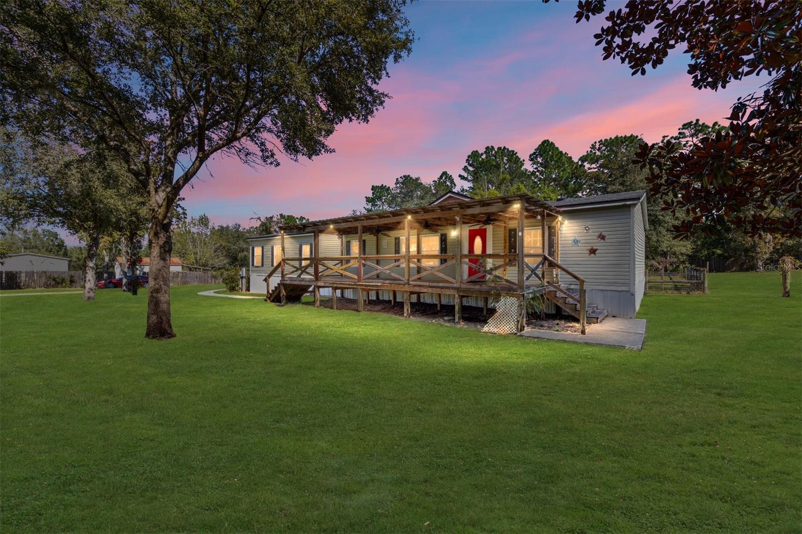 One or more photo(s) has been virtually staged. Breathe in the quiet country air at this charming Williston retreat! Set on 2 oak-shaded acres, this 4 bedroom, 2 bathroom home offers the space you want and the lifestyle you’ve been dreaming of. The open floor plan, oversized kitchen island, and freshly painted interior make the heart of the home warm, bright, and inviting. Every bedroom features brand-new carpet, and with a 2024 roof, and updated 2018 windows & AC, you can move in with confidence.
Bring your pets, & bring your toys to this beautiful property. It is already set up with a carport, shed, and dog kennels, plus plenty of open land to expand, garden, or create your own mini-farm. Mature oak trees provide shade, character, and the perfect backdrop for morning coffee or evening sunsets.
Here, you’re close to conveniences, but far enough to enjoy peace, privacy, and the beauty of rural Florida living.