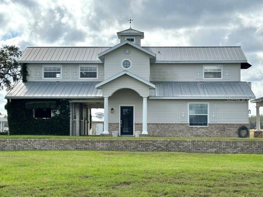 Just under 10 Acres, 2 Apartments house styles with spacious room for renovations. Guest apartment generating $4k plus monthly with Air bnb. Equestrian Estate with amazing sunsets & the LUSHEST grass you will find in Florida! This property features a total of 2 Residences totaling over 6000 sq ft. under roof, 2 block horse barns with 7 stalls and a gorgeous 40x20 pool, spa. The main residence is a lovely 2 bed up, 2 bath block home/metal roof with an attached oversized 31x21 three car garage/workshop and porte-cochère. This area could easily be finished off for more main-level living space adding 650 more to the main residence which features European charm with marble counter tops, stainless appliances, wood floors, tile floors, custom woodwork, pedestal sinks, a claw-foot tub, walk-in shower and breathtaking views of the property. There are 3 stalls and a breezeway at the main residence that could remain as stalls or be finished off into more living areas. On your way to the main barn, the courtyard has a custom pool, spa, deck, grilling area with kitchen and pergola. The main barn features a metal roof, 4 stalls an aisle, 3 wash racks with Hot & Cold, a finished tack/laundry room under air with a full sink. The air-conditioned finished office has, 2 baths, a kitchenette, wood floors, custom floors, custom wood work, pedestal sinks and a breezeway to the barn. The property is fenced, cross-fenced, has 2 run-in pole barns, 20x8 shed that matches houses out back and a 8x10 feed shed. 4-5 paddocks, water in each paddock, a parking pad, manure and shavings storage. You really must see this property to appreciate it. Horse READY & Income Potential GALORE! Easily Rent stalls and/or Airbnb with an Ideal Location just 20 miles to the Ocean!