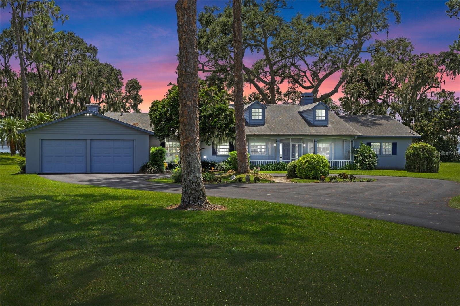 Waterfront Living on Lake Dora – Nearly 1 Acre with No HOA!
Welcome to your private lakefront paradise on the shores of beautiful Lake Dora, part of the renowned Harris Chain of Lakes. Perfectly situated between the vibrant downtowns of Tavares and Mount Dora, this 3-bedroom, 2-bath retreat offers sweeping water views, conveniently located near year-round festivals, top-rated dining, and all the entertainment you could ask for plus only minutes from healthcare including AdventHealth Waterman.
Step through the front door and be instantly greeted by stunning, uninterrupted lake views. The spacious open-concept layout includes a large family room, dining area, and kitchen—ideal for entertaining or soaking in the scenery. A split-bedroom floor plan ensures privacy, and the pool table stays for your entertainment.
Outdoors, an oversized salt water swimming pool takes full advantage of the serene lake backdrop. The pool includes a 50 foot lap lane as well as boasts brand new screens to protect from bugs. The home sits on nearly one full acre of direct lakefront property with a south-facing exposure—perfect for bright, natural light without the heat of direct sun pouring in. Boating enthusiasts will love the private docks and boathouse, complete with an electric lift for easy access to the entire chain of lakes.
A free standing generator that will be left for buyer adds peace of mind during storm season, ensuring uninterrupted comfort and security no matter the weather.
Originally built in 1959, the home underwent a full renovation in the 1990s and has been lovingly maintained. Additional features include a 2-car garage, circle driveway with plenty of parking, no HOA restrictions, and room to expand if desired. Whether you're seeking a peaceful retreat, a vibrant lakefront lifestyle, or a future investment, this property delivers on all fronts.