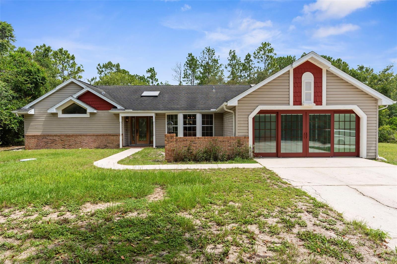 One or more photo(s) has been virtually staged. PRIVATE 5-ACRE MULTI-FAMILY COMPOUND WITH POOL, COMMERCIAL-GRADE WORKSHOP & HORSE-FRIENDLY ZONING! This rare multi-generational property offers TWO SEPARATE PARCELS totaling 5 ACRES in a PRIVATE & SECLUDED setting on the Pasco/Hernando County line, just minutes from the Suncoast Parkway for an easy commute. With NO HOA, this fully fenced estate with ELECTRIC GATE is ideal for horses, livestock, and COUNTRY LIVING while keeping modern conveniences close by. This 4-acre parcel features a beautifully maintained main residence offering 3 BEDROOMS 3 BATHROOMS PLUS FLEX ROOM/ 4th BEDROOM with original SOLID OAK TRIM and SOLID OAK DOORS throughout, SOLID OAK FRENCH DOORS with BUILT IN BLINDS, and gorgeous REAL HARDWOOD FLOORS. The newly renovated kitchen offers GRANITE countertops, abundant cabinetry and counter space, a DOUBLE OVEN, custom recessed lighting, and a brick terra-cotta tile floor and a breakfast bar overlooking a cozy family room featuring a WOOD BURNING BRICK FIREPLACE with a hearty oak mantle. The living spaces are filled with NATURAL LIGHT from both Bay windows and dramatic SKYLIGHTS in the FORMAL LIVING ROOM, FORMAL DINING ROOM and BREAKFAST NOOK, which leads out to the SCREENED POOL and LANAI. The spacious primary suite includes an ON- SUITE perfect for a HOME OFFICE/FLEX SPACE and a SPA LIKE BATHROOM with DUAL VANITY, GRANITE COUNTERS, a GARDEN TUB, separate shower, and private water closet. Additional features include a LARGE LAUNDRY ROOM/MUD ROOM with a window, and a TANKLESS HOT WATER HEATER. The garage was converted to a FLEX ROOM/4th BEDROOM with a stunning wall of OAK FRENCH DOORS with built-in blinds to match the others throughout. The SCREENED LANAI overlooks the serene acreage and offers multiple seating areas for entertaining or relaxing. The detached 40x40 RED IRON NUCOR STEEL FULLY INSULATED COMMERCIAL GRADE WAREHOUSE, is complete with its own 200 AMP electrical panel with plenty of room for additional circuit breakers, 2.5-ton HVAC, ceiling fans, lighting, and enclosed room. Perfect for tradesmen, mechanics, woodworking, or a business, it includes hardware to convert the entry to a garage door if desired. A large, detached shed provides additional storage. THIS IS A MULTI-PARCEL SALE including the 1 ACRE parcel - 5BR/3BA Manufactured Home built in 2019 which offers 2,128 square feet featuring an OPEN FLOOR PLAN, large kitchen with KITCHEN ISLAND, spacious LAUNDRY ROOM/MUDROOM/STORAGE ROOM. The primary suite includes a GARDEN TUB, DUAL SINKS, and a separate shower, and Walkin Closet. The split plan offers privacy and generously sized bedrooms, large closets, and a front DECK make this a perfect GUEST HOUSE or MULTIGENERATIONAL living option. This UNIQUE PROPERTY delivers the perfect blend of PRIVACY, and rural charm while still being close to shopping, dining, and major highways. Whether you're seeking a FAMILY COMPOUND, or income-producing investment, this estate offers it all. Schedule your private tour today and experience the endless possibilities! Price reflects the total of both parcels combined. Parcels will NOT be sold separately and must close together under one contract.