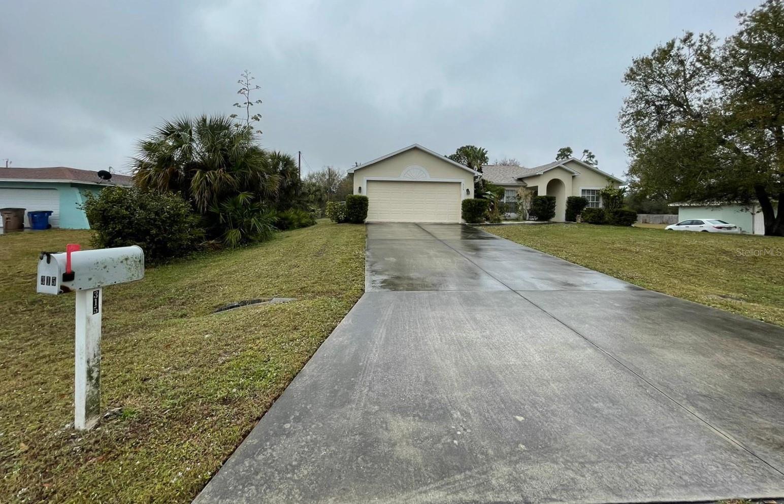 Welcome to 315 5th Ave in Lehigh Acres! This charming 3-bedroom, 2-bath home sits on a spacious half-acre lot in a quiet neighborhood with no HOA and low property taxes. Enjoy the Florida lifestyle with a screened-in swimming pool, child safety fence, and tropical landscaping. The split floor plan offers privacy, while the open kitchen features a breakfast bar and dedicated dining space—perfect for entertaining. Recent updates include a newer roof (2022) and an electric fireplace for cozy evenings. Additional highlights include a covered carport, two-car garage, backyard storage shed, and ample parking. Conveniently located near top-rated schools, shopping, and dining, this move-in ready home offers comfort, space, and value. Don’t miss your chance to make this beautiful property yours—schedule a showing today!
