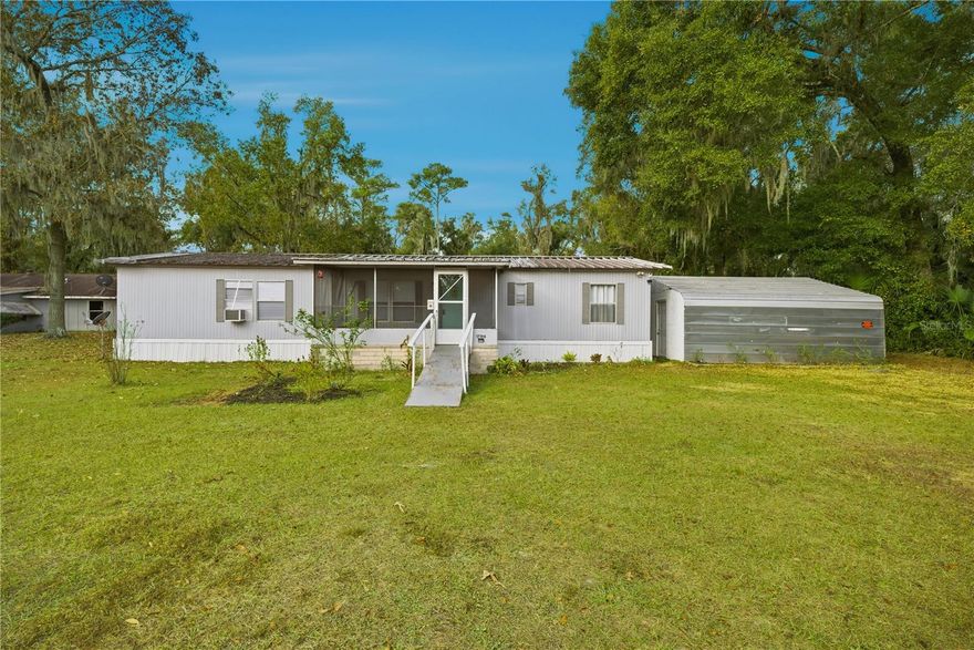 Updated 3BR/2BA manufactured home on nearly ½ acre in Citra! This 1,450 sq ft home features updated bathrooms, an upgraded kitchen, new flooring and new subflooring, and fresh interior paint. Inside laundry, screened-in porch, plus a detached workshop and shed for extra storage. Pest control contract has been maintained, and the yard includes citrus and peach trees for added charm. Conveniently located between Ocala and Gainesville.