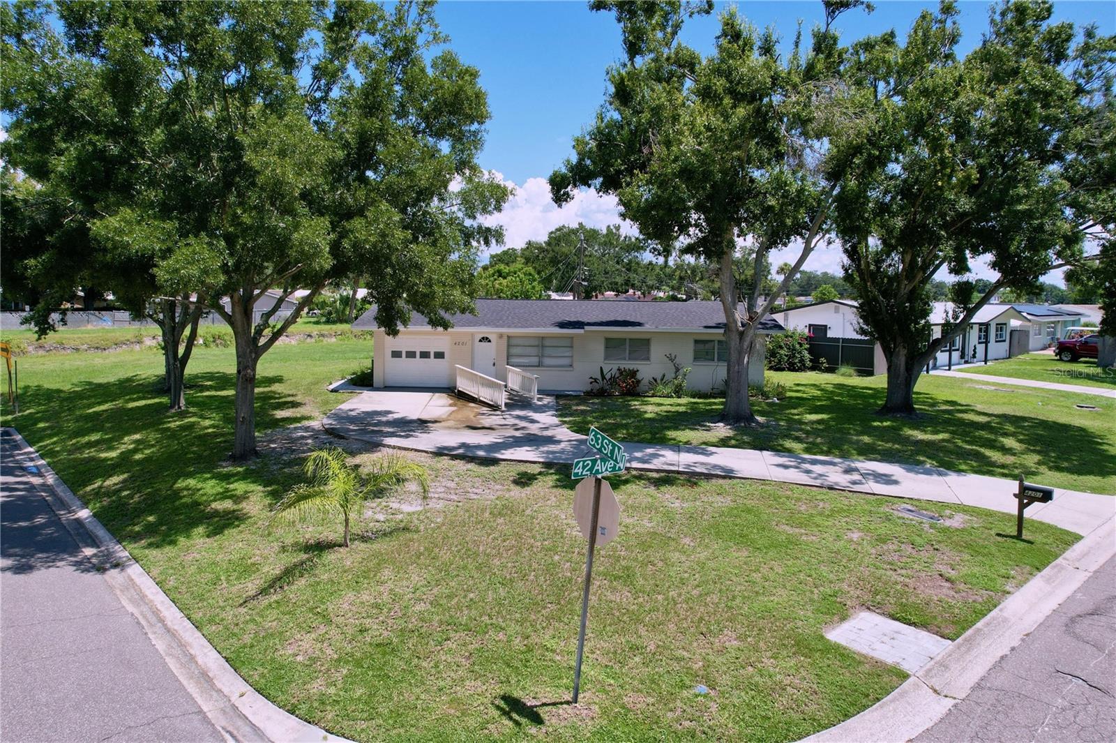 Classy Mid-Century Jewel! Welcome to this beautifully updated 3-bedroom, 2-bath, 1-car garage block home on a huge corner lot in the heart of St. Petersburg. This mid-century classic seamlessly blends timeless character with modern style and thoughtful upgrades throughout. Step inside to a light-filled layout featuring modern wood-look flooring, white wood cabinetry, dazzling granite countertops, and stainless steel appliances. The open design creates a seamless flow, perfect for everyday living and entertaining. Enjoy peaceful mornings or cozy evenings on the spacious paver deck, overlooking a backyard retreat with no rear neighbors! Major updates include: Main roof (2021), Flat roof (2021), HVAC system (2021), Hot water heater (2021), Main sewer line replacement (2024). All renovations were completed in 2021. This home was not impacted by any flooding during last year's hurricanes and enjoys a FEMA zone X so no flood insurance required! Prime Location: Situated in a quiet, established neighborhood with no HOA fees, this home offers close proximity to parks, shopping, dining, and is just minutes away from the gorgeous Gulf beaches. Enjoy the best of Florida’s coastal lifestyle with easy access to sun and sand. Don’t miss the opportunity to own this charming home that perfectly combines comfort and mid-century charm in an unbeatable location!