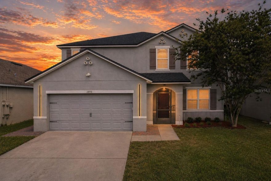 Some homes ask you to compromise. This one asks what you need, then hands it over. Five bedrooms. A flex room. A loft. And the primary suite lives on the main floor, tucked just off the living space with enough distance from the upstairs action to actually feel private when the house is full. The kitchen shows up ready to work with white shaker cabinets, granite counters, stainless appliances, and pendant lighting over a center island that seats the whole crew. It opens to a great room anchored by an electric fireplace with a wood mantel. Vinyl plank flooring runs warm and consistent from front to back. Upstairs stretches out into four more bedrooms, two full baths, a dedicated laundry room, and a loft big enough to pull double duty as a second living space, movie room, or hangout zone. Now the real showstopper. The screened lanai runs the full length of the home and is fully decked out. Linear paver floor, a built-in fire feature, wired for an outdoor TV (think game day BBQs), and seating zones that make weeknight takeout feel like a vacation. This isn't a patio. It's an experience. The big stuff is handled. New roof 2026, water heater 2025, dishwasher 2023, interior paint 2023, vinyl flooring 2022, pavers and screen enclosure 2022 to 2023. Plus LED driveway lights, pull-down garage screen, and an electric fireplace. Canopy Walk is a beautifully maintained community with walking trails, a bark park, playground, and ball field. East Lake Tohopekaliga and the splash pad at Lakefront Park are right down the road. Quick access to the Florida Turnpike and SR-417 puts Lake Nona and Medical City a short drive away, MCO about twenty minutes out, and Disney Springs within easy reach. Primary down stairs. Room for everyone. A lanai you'll live on.