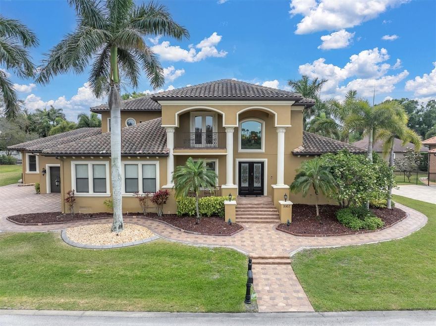 Welcome to 1067 Ashland Ave, a sophisticated Tarpon Springs residence offering over 5,800 square feet of refined living just minutes from Sunset Beach. Designed for both elegance and resilience, this custom home features 4 bedrooms, 6 bathrooms, a 3-car garage, dual lanais, a resort-style pool, Wolf/Sub-Zero kitchen, Tesla backup power, solar panels and a private in-law suite with its own entrance.

The heart of the home is the chef’s kitchen, equipped with Wolf appliances, Sub-Zero refrigeration, custom cabinetry, and an oversized island that flows seamlessly into expansive living and dining spaces. Natural light fills the interior through large windows and sliders, creating a warm, inviting atmosphere.

The primary suite is a private retreat with generous proportions, a spa-inspired bathroom, and custom storage. Three hurricane-rated safe rooms provide peace of mind, while dual Tesla Powerwall backups ensure uninterrupted comfort during storms.

Outdoor living is elevated with two separate lanais—one featuring a fireplace and retractable screens—overlooking a custom pool designed for relaxation and entertaining. Whether hosting gatherings or enjoying quiet evenings, these spaces offer year-round enjoyment.

A rare highlight is the in-law suite, complete with a private entrance, full bath, and living area—ideal for multigenerational living, guests, or extended stays.

Located in one of Tarpon Springs’ most desirable pockets, this home offers quick access to Sunset Beach, Fred Howard Park, the Sponge Docks, and the vibrant local dining scene. Luxury, comfort, and coastal living come together seamlessly at 1067 Ashland Ave.

Shown by appointment.