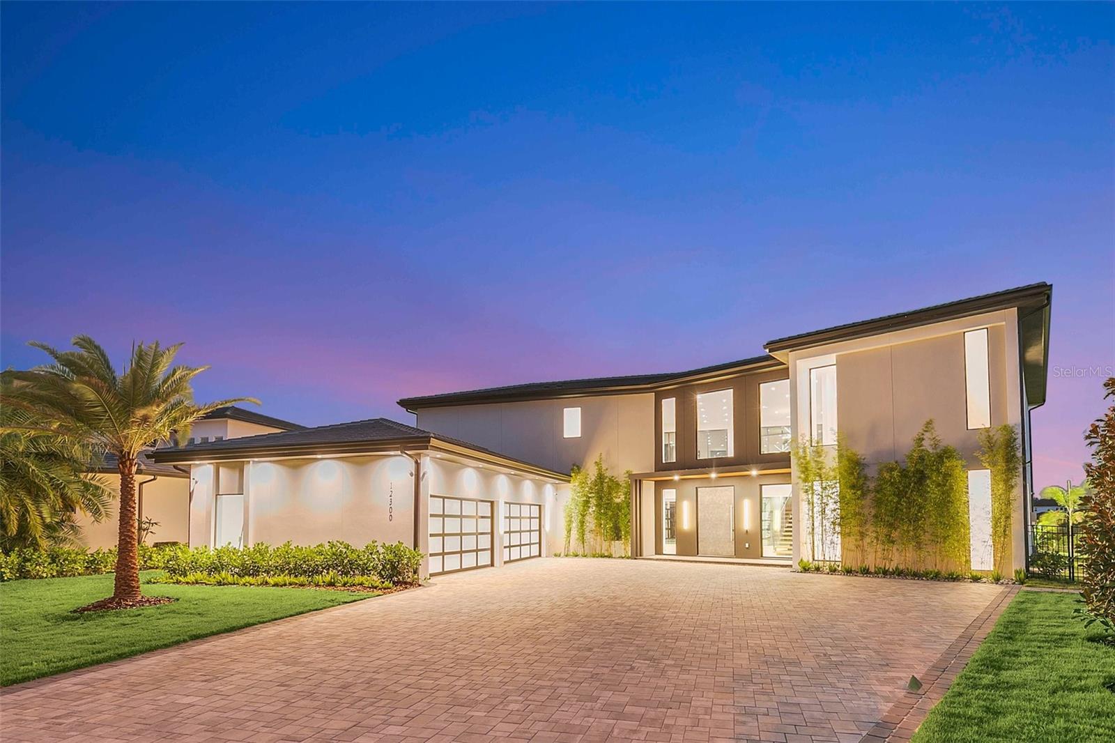 Welcome to your Dream NEWLY BUILT Lakefront paradise in Exclusive Casa Del Lago in Windermere, Florida! This MODERN masterpiece offers the epitome of luxury living with stunning lake views and unparalleled design. On the shores of LAKE BURDEN, this architectural marvel is a fusion of sleek lines, innovative features. Step into a world of elegance as you approach this striking home. The clean lines and bold design create an immediate sense of modern sophistication. The exterior with large windows, inviting natural light to flood the interior and breathtaking panoramas of the tranquil lake and lush landscapes. Opening the Oversized Pivot doors, be prepared to be captivated by the seamless blend of modernity and comfort, featuring full home Control 4 automation. The open-concept with Italian Blond Wood Flooring thru out allows for a seamless flow between the living and outdoor spaces, the dining, and the kitchen areas, making it perfect for both intimate gatherings and grand entertaining. Upon entering you will be greeted with High 26 ft ceilings which adds to the sense of space, and the carefully chosen color palette and premium finishes create an atmosphere of refined elegance.
The gourmet kitchen is a chef's dream, with top-of-the-line Thermador appliances, Gas cooking stations, sleek cabinetry, and a generous center island with exquisite Italian Neolith countertops. The spacious living areas are designed for both relaxation and socialization. The living room boasts large hurricane and impact proof glass sliding doors and oversized windows leading to expansive outdoor spaces, which includes an amazing summer kitchen overlooking your custom designed saltwater pool that seamlessly blends indoor and outdoor living spaces. The home possesses luxuriously sized bedrooms, each with its own en-suite bathroom, all overlooking mesmerizing views of the Lake Burden providing ultimate comfort and privacy. The home provides two master suites. One on the 1st floor with huge glass sliding doors that leads you directly to your breathtaking pool and spa. The main Master Bedroom is on the 2nd floor providing a private oasis, featuring a spa-like bathroom with a soaking tub, walk-in showers, and dual vanities. Imagine waking up to the breathtaking sunrises over the lake from the comfort of your bed or from your private balcony to enjoy the serenity of the water. Step outside to a private oasis of leisure and relaxation. The backyard paradise features a large patio area with automated screens and beautifully designed summer kitchen, ideal for al fresco dining, lounging, or hosting gatherings with friends and family. The sparkling pool overlooking the lake is an inviting spot to cool off on warm days, and the lush landscaping adds a touch of natural beauty to the surroundings. Not to mention your boardwalk that leads you to your own Private boat dock with space big enough to entertain and relax after a day of boating. Windermere, Florida, is renowned for its upscale communities, picturesque lakes, and excellent schools. This home's prime location offers tranquility and convenience, with access to nearby amenities, shopping, dining, and entertainment. Don't miss the opportunity to own this exceptional modern home on the lake in Windermere, Florida. Come and experience the ultimate in contemporary living and make this stunning property your very own private retreat. Schedule your private tour today and let your lakefront dreams become a reality!