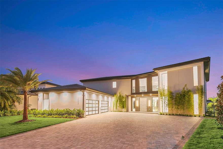 Welcome to your Dream NEWLY BUILT Lakefront paradise in Exclusive Casa Del Lago in Windermere, Florida! This MODERN masterpiece offers the epitome of luxury living with stunning lake views and unparalleled design. On the shores of LAKE BURDEN, this architectural marvel is a fusion of sleek lines, innovative features. Step into a world of elegance as you approach this striking home. The clean lines and bold design create an immediate sense of modern sophistication. The exterior with large windows, inviting natural light to flood the interior and breathtaking panoramas of the tranquil lake and lush landscapes. Opening the Oversized Pivot doors, be prepared to be captivated by the seamless blend of modernity and comfort, featuring full home Control 4 automation. The open-concept with Italian Blond Wood Flooring thru out allows for a seamless flow between the living and outdoor spaces, the dining, and the kitchen areas, making it perfect for both intimate gatherings and grand entertaining. Upon entering you will be greeted with High 26 ft ceilings which adds to the sense of space, and the carefully chosen color palette and premium finishes create an atmosphere of refined elegance.
The gourmet kitchen is a chef's dream, with top-of-the-line Thermador appliances, Gas cooking stations, sleek cabinetry, and a generous center island with exquisite Italian Neolith countertops. The spacious living areas are designed for both relaxation and socialization. The living room boasts large hurricane and impact proof glass sliding doors and oversized windows leading to expansive outdoor spaces, which includes an amazing summer kitchen overlooking your custom designed saltwater pool that seamlessly blends indoor and outdoor living spaces. The home possesses luxuriously sized bedrooms, each with its own en-suite bathroom, all overlooking mesmerizing views of the Lake Burden providing ultimate comfort and privacy. The home provides two master suites. One on the 1st floor with huge glass sliding doors that leads you directly to your breathtaking pool and spa.  The main Master Bedroom is on the 2nd floor providing a private oasis, featuring a spa-like bathroom with a soaking tub, walk-in showers, and dual vanities. Imagine waking up to the breathtaking sunrises over the lake from the comfort of your bed or from your private balcony to enjoy the serenity of the water.  Step outside to a private oasis of leisure and relaxation. The backyard paradise features a large patio area with automated screens and beautifully designed summer kitchen, ideal for al fresco dining, lounging, or hosting gatherings with friends and family.  The sparkling pool overlooking the lake is an inviting spot to cool off on warm days, and the lush landscaping adds a touch of natural beauty to the surroundings. Not to mention your boardwalk that leads you to your own Private boat dock with space big enough to entertain and relax after a day of boating.  Windermere, Florida, is renowned for its upscale communities, picturesque lakes, and excellent schools. This home's prime location offers tranquility and convenience, with access to nearby amenities, shopping, dining, and entertainment. Don't miss the opportunity to own this exceptional modern home on the lake in Windermere, Florida. Come and experience the ultimate in contemporary living and make this stunning property your very own private retreat. Schedule your private tour today and let your lakefront dreams become a reality!
