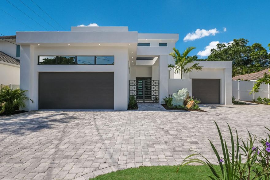 One or more photo(s) has been virtually staged. ABSOLUTELY STUNNING WEST OF THE TRAIL MODERN POOL HOME! This custom-built home was literally JUST COMPLETED (2023) and has everything today's discerning buyers are looking for in a home! Offering 4 bedrooms plus an office, 5.5 bathrooms (all en-suite), and a 3 car garage...This home truly has it all! Perfect location, extremely well-thought-out floor plan, and outdoor living space that will make you want to call this house your home!!! As soon as you pull into the paver brick driveway and see the gorgeous tropical landscaping surrounding this sleek design you will fall in love.  The gated courtyard entrance enhances the front entryway that focuses on natural light giving this home a warm feel. Throughout the living areas, you will find beautiful wood floors, high ceilings, and 8-foot doors that give this already large home an airy and open feel. The great room combines the family room and kitchen area which is perfect for entertaining friends and family. The kitchen is every chef’s dream with custom cabinetry, quartz countertops, and Bosch appliances including a gas range. The large island offers seating with pendant lighting so that you can truly enjoy the kitchen as the heart of the home. Right off the kitchen is the lovely butler’s pantry with loads of storage as well as a built-in coffee machine and an 80-bottle wine fridge. The large living space has an electric fireplace with a stone feature wall that serves as the centerpiece of the room as well as a wall of sliding glass doors leading out to the pool area. The master suite is located off the living area and is truly its own wing of the home. You will love the size of the master bedroom and his and her custom walk-in closets. The bathroom will stop you in your tracks with the detailed finish work and large soaking tub. The huge walk-in shower offers custom tile work along with rain shower heads. Additional downstairs space includes a powder room for guests and a laundry room with a washer, dryer, laundry sink, and the best part...a built-in steamer! Upstairs you will find a huge 2nd living room/bonus room as well as a formal office. Additionally, all three bedrooms upstairs have en-suite bathrooms. A terrific split bedroom layout that enables the upstairs occupants to also have their own living space! The pool/backyard area is simply outstanding! You will feel like you are at your own private resort. The owners spared no expense to make this area a tropical paradise with tons of landscaping, a paver brick pool deck, artificial turf, and an 8-foot fence for maximum privacy. The oversized pool leads into the 8-person spa. Additional spaces include a wet bar with cabinetry and a full bath designated for the pool. Next to the pool is a fire pit that is the perfect place to sit with friends and wind down the day. The bocce ball court/putting green is a great use of space and offers fun for everyone! Everything about this location is ideal...A rated school district! Minutes to shopping and restaurants! Minutes to the Siesta Key beaches! Around the corner from Red Rock Park and the highly desired Field Club!  YOU SIMPLY WILL NOT FIND A BRAND NEW HOME WEST OF THE TRAIL WITH ALL OF THESE AMENITIES AT A BETTER PRICE!!!