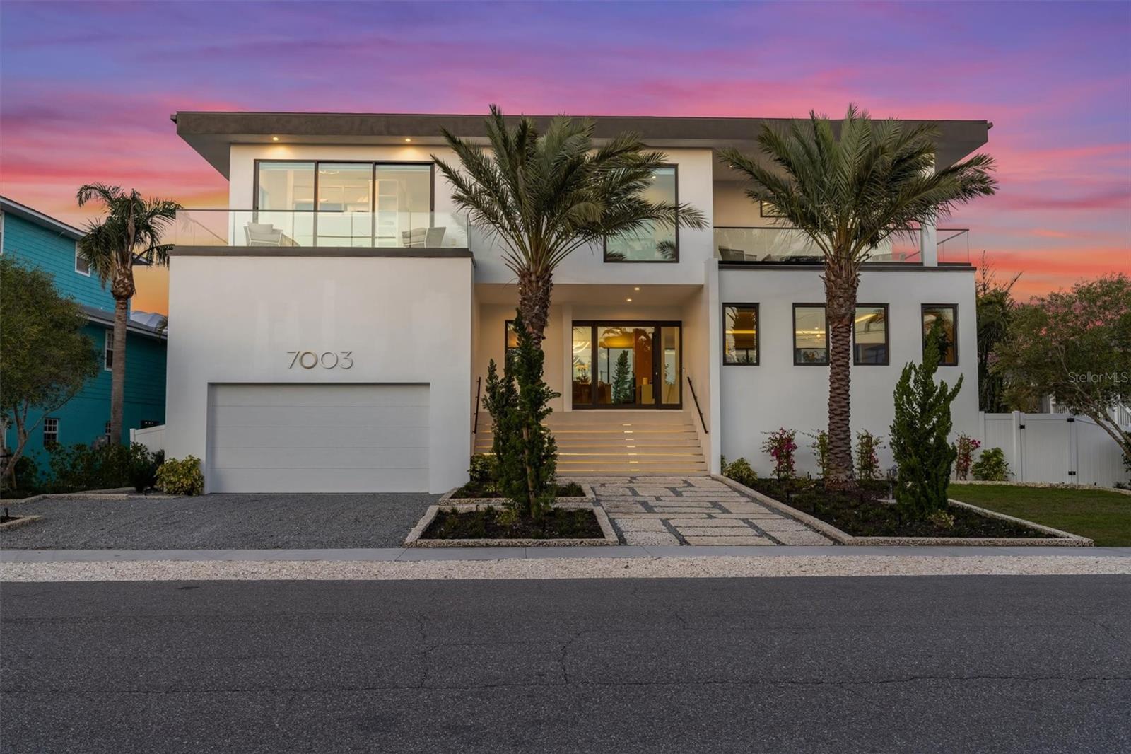 Welcome to your dream modern retreat! This brand-new, custom-built masterpiece offers 4 spacious bedrooms, 4.5 luxurious baths, and an unparalleled blend of elegance and comfort. Nestled just steps from the Gulf beaches of Holmes Beach, this stunning home is designed for both relaxation and entertainment.  Step inside to discover an open-concept living space bathed in natural light, entire walls of floor to ceiling impact slider doors, high-end finishes and modern craftsmanship throughout. There are 2 living space areas, perfect for big families. The gourmet kitchen is a chef’s delight, perfect for hosting, induction stove, double oven, wine fridge, pantry and more! Each bedroom is a private oasis in itself, complete with en-suite fun tiled bathrooms and all have their own balcony for ultimate convenience and privacy.  More features include laundry room with sink and storage, 2 car garage, fun wallpaper throughout and high end chandelier’s. Outside, your personal paradise awaits—a sparkling heated infinity pool and rejuvenating spa create the ideal setting for unwinding or soaking up the Florida sunshine. Steps go down to the yard and the oversized dock, on the lagoon fun for fishing! Located in the heart of Holmes Beach, you’re just moments from the sugar-white sands and turquoise waters of the Gulf, offering the best of island living.  Don’t miss this rare opportunity to own a slice of paradise—schedule your private tour today!