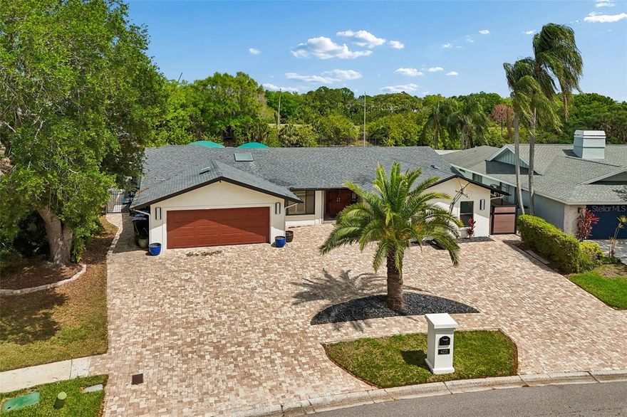 In the gated waterfront community of Sweetwater, this single-family residence offers direct access to Tampa Bay with no bridge restrictions, designed for seamless boating and waterfront living. The composite dock features two covered boat lifts with approximately 25,000-pound and 10,000-pound capacities, accommodating multiple vessels with ease. The residence spans just over 2,800 square feet and features a split-bedroom layout with four bedrooms, three full baths and one half bath. The primary suite is privately positioned and includes dual closets, sliding glass doors with direct access to the pool area, a soaking tub and an expansive walk-in shower. On opposite side of the residence, three additional bedrooms include a private en suite, offering flexibility for guests or multigenerational living. The open-concept floor plan connects the kitchen and living areas, creating a functional layout for everyday living and entertaining. The kitchen is appointed with upgraded appliances, including a Sub-Zero refrigerator and Bosch range, along with ample cabinetry and workspace. Tile flooring extends throughout the main living areas. Outdoor living includes an expansive pool area with a covered seating space, wet bar and beverage refrigerator. The waterfront setting enhances the outdoor experience with direct access to open water. Additional features include a three-car garage and paver driveway.