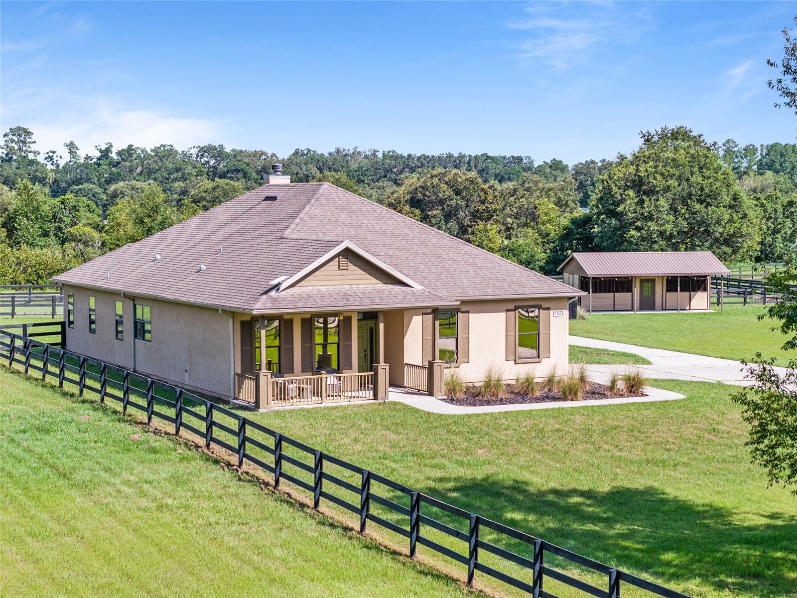 Equestrian Paradise in Bridle Ridge, a serene horse lover's haven in the heart of Ocala, Florida! This charming community offers the perfect blend of tranquility and convenience, located just minutes from the World Equestrian Center and HITS, making it an ideal spot for equestrian enthusiasts. Property highlights include a detached garage with EV Charger. 2-Stall Barn with Tack Room. Fully fenced pastures with cross fencing. Secure and private, with easy access gates for your horses. Inside the charming house you step into a thoughtfully designed floor plan, featuring a stunning floor-to-ceiling stone fireplace, perfect for cozy evenings. A functional and stylish kitchen is equipped with granite countertops, soft-close cabinetry, and ceramic tile flooring throughout for elegance and easy maintenance. Additional features include an expansive Florida Room where you'll enjoy sweeping views of lush pastures. The Owner’s Suite Retreat is spacious enough for a king-sized bed, providing a restful haven. Two generous guest rooms plus a third bedroom that can be easily converted into a home office. Inside laundry with washer and dryer for everyday ease. This property isn’t just a home; it’s a lifestyle. Whether you’re hosting friends, riding your horses, or simply relaxing in your Florida Room with panoramic pasture views, Bridle Ridge offers a perfect blend of comfort, functionality, and equestrian elegance. Don’t miss the opportunity to own a slice of Ocala’s horse country!