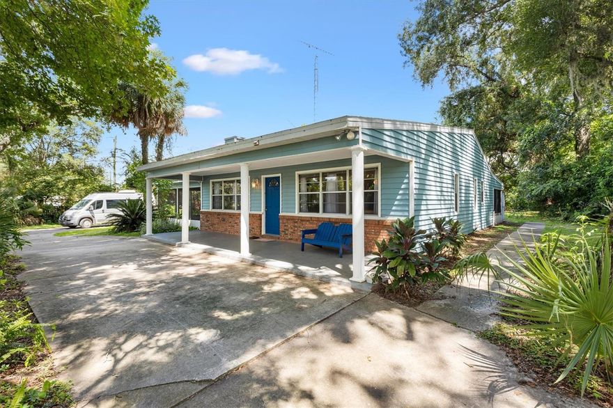 Welcome to your countryside retreat: a delightful 3BD/2BA home offering 1,780 SQF under air nestled on a 5-acre estate plus a versatile 1,600 SQFT barn for all your hobby or storage needs. Located in the unincorporated but rapidly growing community of Wildwood—just west of The Villages—this property offers the ideal balance of tranquil rural living and modern convenience, with easy access to major routes like I-75, US-301, and CR-466, and proximity to amenities such as parks, local wineries, restaurants, and shopping. Surrounded by mature oaks and lush greenery, this home welcomes you with a bright blue front door and a wide covered porch—perfect for morning coffee or peaceful evenings. The exterior showcases a tasteful mix of classic brick and pastel siding, adding a hint of cottage-style warmth to the rural setting. Step inside to discover beautifully tiled floors that extend throughout the main living areas. Exposed dark wooden ceiling beams add character and warmth, drawing the eye upward. The layout flows effortlessly, connecting living, dining, and kitchen spaces into one harmonious, flexible zone. The spacious kitchen boasts a large center island ideal for cooking and casual dining. You'll find laminate countertops, crisp white cabinets, and stainless-steel appliances—including a full-size refrigerator, stove, and microwave. The backsplash features a chic geometric tile pattern, giving the kitchen a modern touch with a hint of vintage charm. The amster suite is impressive with with a walk-in closet and an ensuite featuring a tile shower. The spare bedrooms are spacious with a shared guest/hall bathroom featuring a built in makeup vanity. A bonus sunroom provides even more space for entertaining or family time. Recent upgrades include a new roof (2023), a new well (2025), and a screened porch for added comfort and functionality. The barn consists of a HVAC system, three stalls, as well as a finished office/dog kennel, and the pasture area is spacious—perfect for livestock or hobby farming. With endless possibilities, this property is ready to realize your vision—don’t wait, call today to schedule your personal tour!