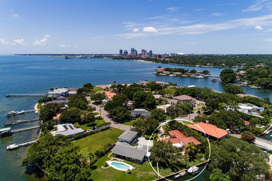 Four bedroom, 3 bath, canal-front home located on one of the most sought after streets in all of St. Petersburg. Bay Point Drive is a circular island situated off Brightwaters Boulevard in Snell Isle. Consisting of just 31 homes, this circular street is its own private enclave where through-traffic is seldom and lots are in high demand. Completely remodeled in 2006-2007 by Bright Bay Builders, this solid house features timeless upgrades such as travertine flooring throughout the first floor, an oversized double garage, huge yard, spacious primary bed and bath and an outdoor fireplace. Custom wood cabinetry, stainless appliances, solid surface counters and windows, windows, windows make this home unique. The first floor features an L-shape open design around a cozy covered lanai and pool. See dolphin, manatee and magnificent birds just out the backdoor, where banks of glass sliders welcome in the outdoors. Two bedrooms, a spacious bath and a landing workspace office upstairs are great for family members working from home or visitors staying more than 3 days. At the ready is an electric boat lift and dock making your weekend water getaways to downtown, Weedon Island, Tampa and the Gulf of Mexico, just a short cruise away. No bridges and year-round deep-water access to Tampa Bay and all the great boating spots is another plus. The neighborhood of Snell Isle is located just a walk or bike ride from vibrant downtown St. Petersburg where green waterfront parks, restaurants and museums have turned this city into a spectacular international destination.