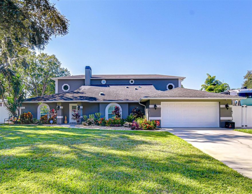 Where performance meets perfection—this Odessa estate, owned by a17-time road racing champion and her husband, was built for those who live life in the fast lane yet crave serenity when the engines quiet. Spanning 4,690 sq ft on a .77-acre fully fenced lot, this modern, open-concept home is a masterclass in design, functionality, and versatility. With 6 bedrooms/4 full baths, it features two identical primary suites—one on each level—offering multi-generational comfort and privacy. A third ensuite and three additional bedrooms are thoughtfully arranged across separate wings, ideal for guests, family, or home offices. Outside, the resort-inspired living area invites relaxation and entertainment. The lanai showcases colorful pavers, wood plank ceiling, dual fans, and an expansive free-form heated chlorinated pool with in-water sundeck and water feature surrounded by lush tropical landscaping. A tranquil koi pond with stone accents sits nearby, while a long paver walkway leads to a patio and firepit, continuing to a Jasmine fragrance, lighted pergola—a dream setting for evening gatherings and   magnificent sunsets right from your very own oasis. Car enthusiasts and hobbyists will appreciate dual double-wide driveways with double gates flanking the home, providing ample space for boats, RVs, or trailers. The property includes an attached 2-car garage, an 880 sq ft finished insulated building with two 10’ roll-up doors, full climate-control, checkerboard flooring, office space with 75” TV, cabinet and sink, and a concrete platform entrance. Two additional outparcel buildings along the fenced driveway serve as storage or workshops. 75’ concrete pad to accommodate a motorhome complete with 50amp service outside and a pump-out station. 50amp also available in 2-car garage. The home’s interior open design seamlessly connects the kitchen, dining, living room into one expansive, light-filled space with 3 tubular skylights. High ceilings and wide-plank wood floors enhance the sense of flow and warmth. The family room centers around a stone-surround wood-burning fireplace, framed by vaulted ceilings, crown molding, and recessed lighting that define the home’s architectural elegance. At the heart, a precision-crafted gourmet kitchen unites performance and elegance in a true showpiece. Tall custom cabinetry, pull-out pantries, crown molding, under-cabinet lighting, and exotic granite counters framed by a stacked-stone backsplash evoke timeless sophistication. A central island with convection cooktop anchors the space, while the freestanding counter-height breakfast bar—complete with stainless farmhouse sink, wine refrigerator, and glowing pendant lights—creates a dramatic focal point for gatherings. Next to the kitchen, a flex space with a staircase, storage, and French door to the lanai adapts easily as an office, playroom, or reading nook. A hallway leads to a pantry and bedroom. Upstairs a 30x20 media room delivers the ultimate cinematic experience with premium theater seating for eight—arranged in two rows of four, the back row on a raised platform—facing a 150” projection screen. Its immersive design brings movie and sports to life creating a true home theater. Space for a bar setup, a long storage closet and adjacent primary suite offers comfort and privacy just steps away from the action. Exceptional Odessa home blends luxury, comfort, and performance—don’t miss your chance to own this one-of-a-kind property—schedule your private showing today!