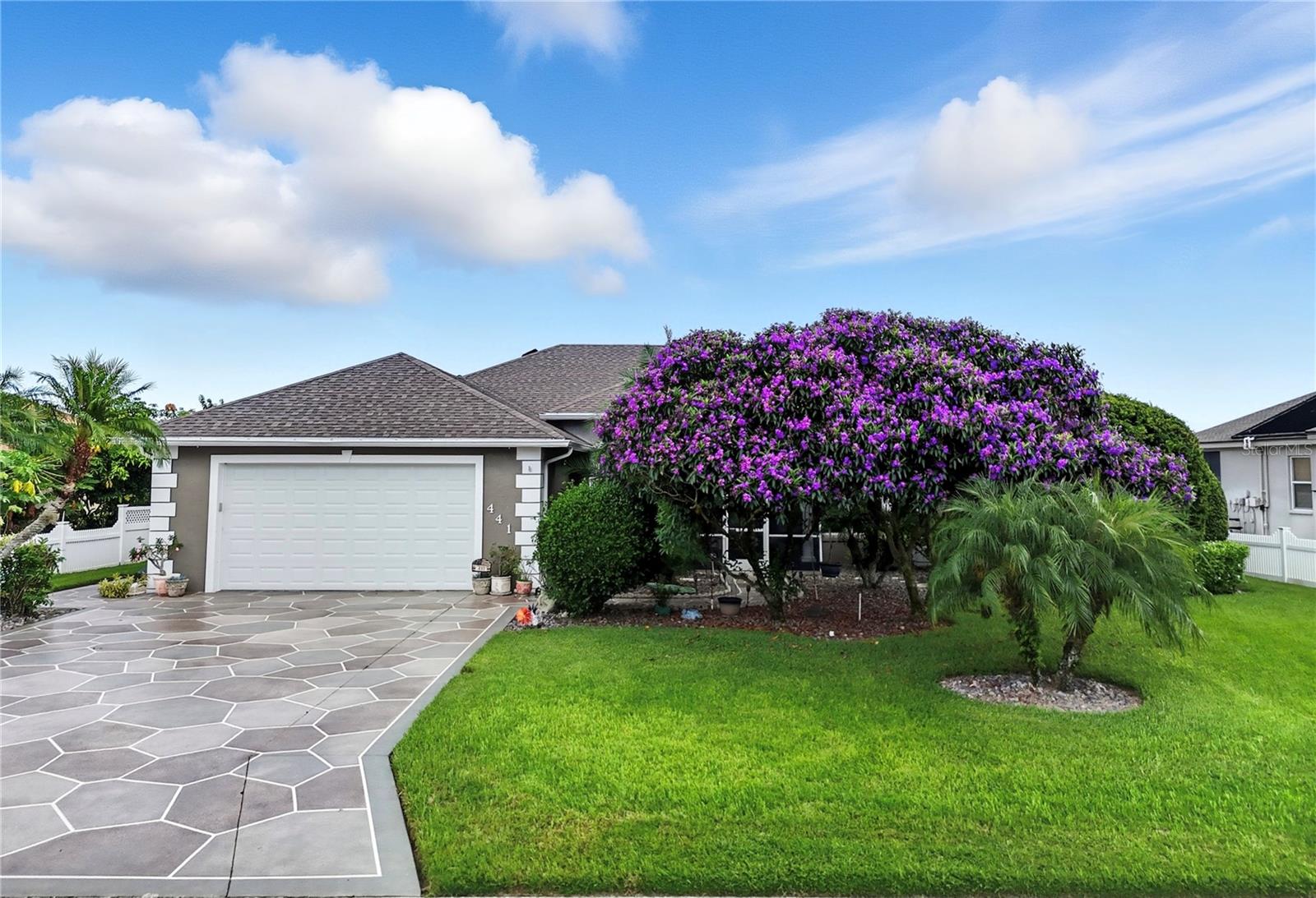Discover this spacious & stunning lakefront 4BR, 3BA home where elegant living & breathtaking panoramic views create the perfect Florida lifestyle. This lakeside haven is ~3000 sq ft LA & has upgrades galore including new windows, granite countertops, lots of ceiling fans & engineered hardwood floors throughout with upgraded tile in the wet areas. Enter into a spacious, light-filled foyer facing formal areas with high ceilings. Perfect for gatherings, the formal dining room boasts an ornate mirrored wall & a picturesque arched window with plantation shutters. The living room is complemented with triple-glass sliders leading out to the pool area with serene waterfront scenery, where sparkling lake views become part of your everyday backdrop. The beautifully remodeled gourmet kitchen features tall cabinetry with crown moulding, granite counters & backsplash, modern under lighting, & comes fully equipped with all of the upgraded appliances . A quaint dinette area with a seamless window overlooks the pool & lake with a door conveniently leading to the patio. The cozy yet hosting-ready family room boasts 2 bright & cheery windows with recessed shades, a gasp-worthy lake view, & an 85" TV placed in between that stays with the home. This desirable triple split BR plan offers all generously sized rooms. Because of its close proximity to the formal areas, the 4th BR is ideal as an office with its French doors & plantation shutters. The primary BR includes a sitting area & 2 nice walk-in closets. The primary BA offers a whirlpool tub, tiled walk-in shower, & dual granite vanities. The laundry room offers ample cabinetry, granite counters, a conveniently placed sink & comes complete with W/D. Both guest BAs are remodeled: one with tub/shower combo, the other with a walk-in shower & direct pool access. Outdoors, the large screened pool & patio invite endless relaxation with multiple covered sitting areas, a passthrough window from the kitchen & a mini fridge for convenience. The solar-heated pool with waterfall becomes the centerpiece, framed by serene lake views. Beyond the screen, the backyard transforms into your private retreat: an expansive lawn leading to a sandy beach with protective seawall, a sun deck with pavers & firepit for unforgettable evenings, & a long dock stretching into the lake with a covered section complete with electricity & an overhead fan. Additional features include a double car garage, irrigation system, full-house portable generator with propane tanks, intercom, solar attic fans for energy efficiency, Aquasana water filtration system, Ring security system, & Armor hurricane screens for the entire house. Recent updates include: roof (2024), zoned C/H/A (2020), house repaint (2024), driveway redo (2024), tankless gas water heater (2023), pool cage (2023), pool pump & deck (2024), & new piping for pool solar panels (2023). Whether for close-knit evenings or lively gatherings, this home showcases lakefront living at its finest! Best yet, it's nestled in a gated community w/ an abundance of community amenities including a nice clubhouse, a large swimming pool, tennis, pickleball, basketball, a playground, a boat ramp & a dock onto Spirit Lake. This beauty is located in the heart of Central Florida w/ easy access to the Polk Parkway making it convenient & easy for commuting to Lakeland, Tampa or Orlando! All measurements are approximate.