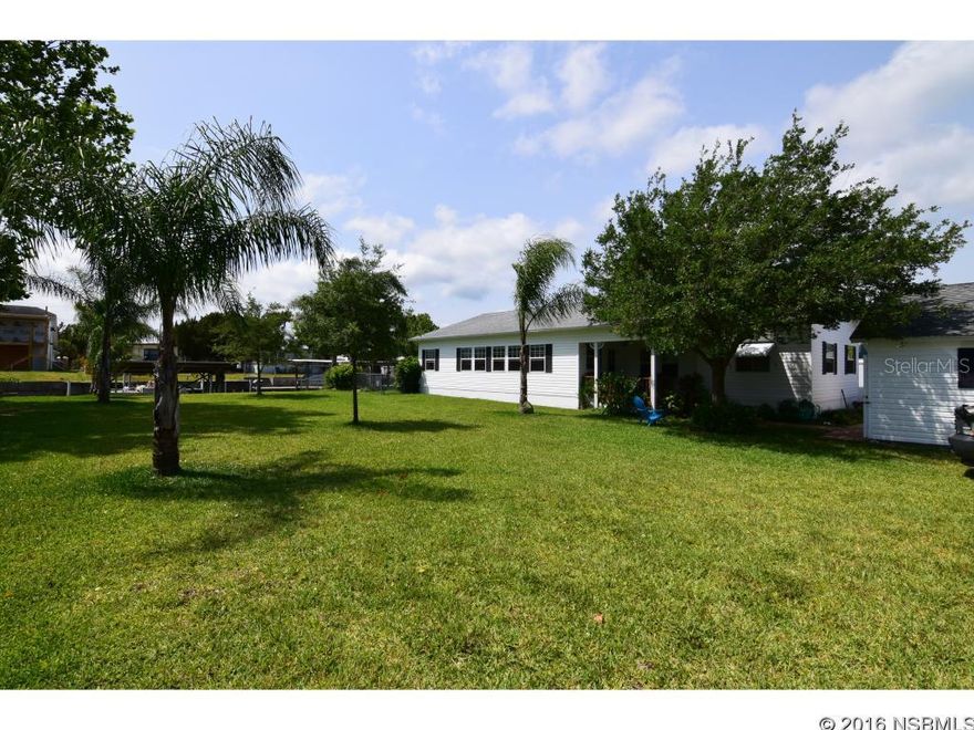Wonderful family home with river breezes and fantastic views of the river.  This well cared for home sits 3 lots from the intracoastal waterway with 100ft of seawall , 2 covered docks, fish house/tackle room, tropical landscaping and many custom features.  There is a sunny 25' Florida Room facing east , huge master bedroom with plenty of storage, open large laundry/utility room , covered BBQ area and a new Swim Spa for your enjoyment. There is also a large separate 2 car garage extra deep with workshop space.  This is a rare find at the end of a quiet cul-de-sac. ;Water: City