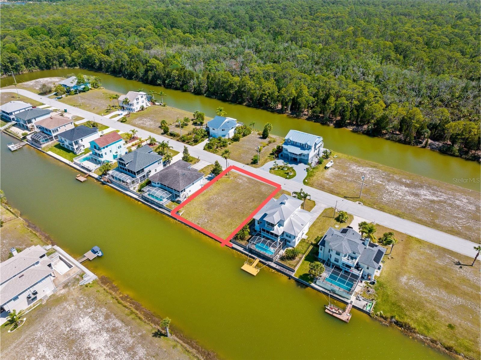 This beautiful canal-front residential lot on Palometa Drive is located in the highly desirable, deed-restricted boating community of Hernando Beach South, along Florida’s Nature Coast. The lot spans approximately 7,500 square feet and offers 75 feet of water frontage, providing direct backyard access to the community's wide canal system and a short ride to the Gulf of America via a community-maintained boat lift. Zoned R1B – designated for single-family residential homes only, supporting peaceful, low-density living.
No short-term rentals allowed – preserving the integrity and tranquility of the neighborhood.
Located in a flood zone– elevated construction is required, as is typical for waterfront homes in this coastal region.
Public utilities – water, sewer, and electricity available at the street.
No seawall currently installed – a blank canvas for designing a dock or lift to suit your boating lifestyle Hernando Beach Sou is a golf cart-friendly neighborhood known for its tight-knit, relaxed coastal atmosphere. Enjoy access to a private community boat ramp, allowing for easy launch and recovery of your watercraft. Dolphins, manatees, and coastal birds are regular visitors in the area’s scenic waterways. Just a short cart ride or walk to local waterfront restaurants, including seafood spots, tiki bars, and sunset views. Close to natural preserves like the Weeki Wachee Springs and Weeki Wachee Preserve, offering hiking, kayaking, and eco-tourism. This lot is an ideal opportunity to design and build your dream waterfront home in one of Florida’s most peaceful and scenic boating communities.