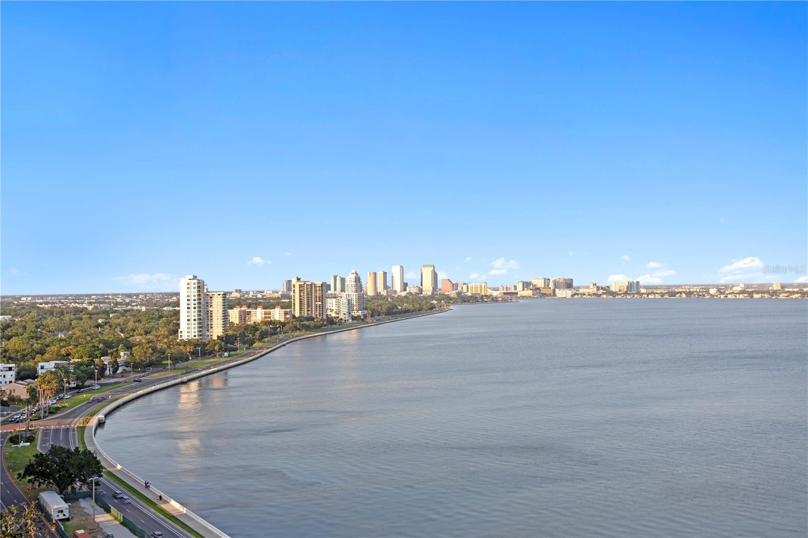 Welcome to the pinnacle of luxury living on the iconic Bayshore Boulevard! Balcony Unit designed by renowned interior designer Tommy Lamb, this extraordinary sky-high residence spans over 4,100 SF on the 22nd floor, offering unobstructed, panoramic views of Tampa Bay, Hillsborough Bay, and Downtown Tampa. This fully customized 4 bedroom, 4.5 bath home seamlessly combines two units into one breathtaking masterpiece where no detail has been overlooked. Step off the elevator into your private foyer and experience rich wood floors with porcelain tile inlay, setting the tone for the exceptional craftsmanship throughout. The expansive living space features floor-to-ceiling windows, a custom wet bar, and sweeping views—perfect for entertaining. The chef’s kitchen is a showstopper, featuring Italian cabinetry, a 96-bottle wine display, walk-in pantry with prep sink, and premium Wolf and Sub-Zero appliances. A hidden butler’s pantry, two wet bars, and a formal dining room that comfortably seats 12 elevate your hosting game. The luxurious primary suite includes a private balcony, spa-inspired bath, and a massive custom closet with water views. All guest suites offer en-suite baths and stunning vistas. Additional features include smart home automation, custom lighting, electronic roller shades, vanity mirror TV, and bespoke closets throughout. Enjoy the convenience of 3 dedicated parking spaces, a private storage unit, and a climate-controlled storage cage. Monte Carlo Towers offers resort style amenities: a 24,000 SF marble lobby, 24-hour concierge, two guest suites, heated pool, grilling area, social room with commercial kitchen, library, fitness center with saunas, and tennis/pickleball courts. Located in a top-rated school district and just minutes to Downtown, Hyde Park, SOHO, Riverwalk, and Tampa International/St. Pete Clearwater Airports, easy access to major highways, including I-275, I-4, and the Selmon Expressway with the nation’s longest continuous sidewalk right outside your door. Experience elevated living at its best—schedule your private tour today!