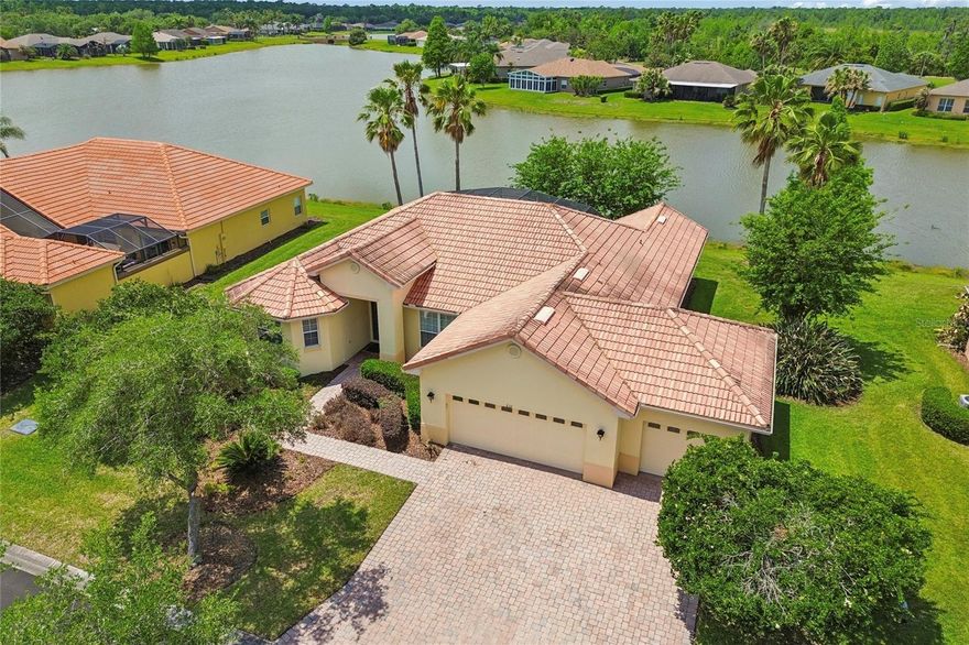 Welcome to this lovely, move-in-ready Carnegie model featuring a rare THREE CAR GARAGE , a barrel tile roof, and gorgeous  WATER VIEWS. Enter through elegant LEADED GLASS door with sidelights into a bright and inviting space. The living and dining rooms showcase CERAMIC TILE ON THE DIAGONAL, tall ceilings, CROWN MOLDING, and stunning sight lines to the water through triple sliding glass doors. The kitchen is both stylish and functional, offering solid wood cabinetry with PULL-OUT SHELVING, newer STAINLESS STEEL APPLIANCES installed in November 2025, and a convenient BREAKFAST BAR that opens to a casual dinette area. HVAC REPLACED IN 2025 with BOSCH System and includes  10 YEAR PARTS AND LABOR WARRANTY. The private PRIMARY SUITE is thoughtfully positioned on one side of the home and features DOUBLE-DOOR ENTRY, a spacious layout, plush carpeting, crown molding, linen closet, and TWO LARGE WALK-IN CLOSETS. Sliding doors lead directly to the lanai, perfect for easy access. The ENSUITE BATH includes a glass-enclosed WALK-IN SHOWER, garden tub, split vanities with DUAL SINKS, and a private water closet. On the opposite side of the home, a second bedroom and full bath provide comfortable accommodations for guests or family members. The family room is the perfect place to unwind, offering additionall water views and another set of sliding glass doors that open to the outdoor living area—ideal for enjoying Florida evenings. The EXTENDED and SCREENED lanai offers WIDE OPEN WATER VIEWS, perfect for enjoying Florida SUNSETS!! Whether you’re relaxing with a glass of wine or entertaining friends, this outdoor space is ideal for enjoying Florida living at its finest! This property has been used as a SEASONAL RESIDENCE and has been impeccably maintained—don’t miss out, schedule your showing today! Home can be sold TURNKEY FURNISHED. The HOA: - maintains the LANDSCAPING & IRRIGATION systems in the common areas as well as at individual homesites - maintains the roads throughout the community - PROVIDES SECURITY with gate guards and mobile patrols including the Polk County Sheriff - allows AUTOMATED GATE ACCESS for residents via license plate readers - provides residents with Fiber Optic Internet & TV service.***Poinciana Lakes Plaza is a MAJOR NEW SHOPPING CENTER directly across from the Solivita Main Gate. It features Sprouts Grocery, TJ MAXX, Ross, Burlington, Rack Room Shoes, 5 Below, Ulta, Outback, First Watch, 5 Guys, Panda Express, Bojangles, Jersey Mike's Subs, 5 Guys, Papa John's Pizza, Burrito Bar, Cold Stone Creamery, Urgent Care, Dentist, Hand & Stone Massage, America's Best Eyeglasses, Crunch Fitness, Hair Cuttery, Petco, TD Bank, Verizon Mobile, PLUS MORE TO COME.***