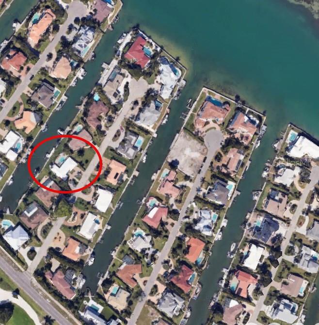 An exceptional chance to acquire a prime waterfront residence on the Southern tip of Longboat Key, ideally situated along a wide waterway leading to Sarasota Bay (with no bridges). Located in one of the most desirable areas, this home is just a short walk or bike ride to your deeded beach access, the prestigious Longboat Key Club, and the new St. Regis hotel. Enjoy beautiful beaches, world-class dining, St. Armands Circle, and more. With over 100 feet of canal frontage, this property features deep, sheltered waters perfect for boating, with direct access to the Intracoastal Waterway, Sarasota Bay, and the Gulf of Mexico. The home offers an excellent foundation, a beautiful pool, a new roof, and a new seawall with a jet ski lift for your dream waterfront retreat. The location also offers convenient access to downtown Sarasota, known for its vibrant arts and cultural scene, and Sarasota International Airport, making it the perfect balance of coastal living and accessibility. Although the current home has sustained damage from the hurricane, it presents remarkable potential. The minimal water and drywall were removed within 24 hours of intrusion. The 12,392-square-foot lot offers numerous possibilities. Embrace the Longboat Key lifestyle with deeded beach access, easy boating, and proximity to the island's top amenities. Memberships at the Longboat Key Club provide access to world-class golf, a premier tennis center, and a private beach club. With a rare combination of location, water access, and potential, this home presents an unparalleled opportunity to create your ideal waterfront retreat. A short stroll to the deeded beach offers the chance to relax, enjoy the sun, and witness breathtaking sunsets. Don't miss this opportunity to create your ideal waterfront lifestyle in one of Longboat Key's most desirable communities.
