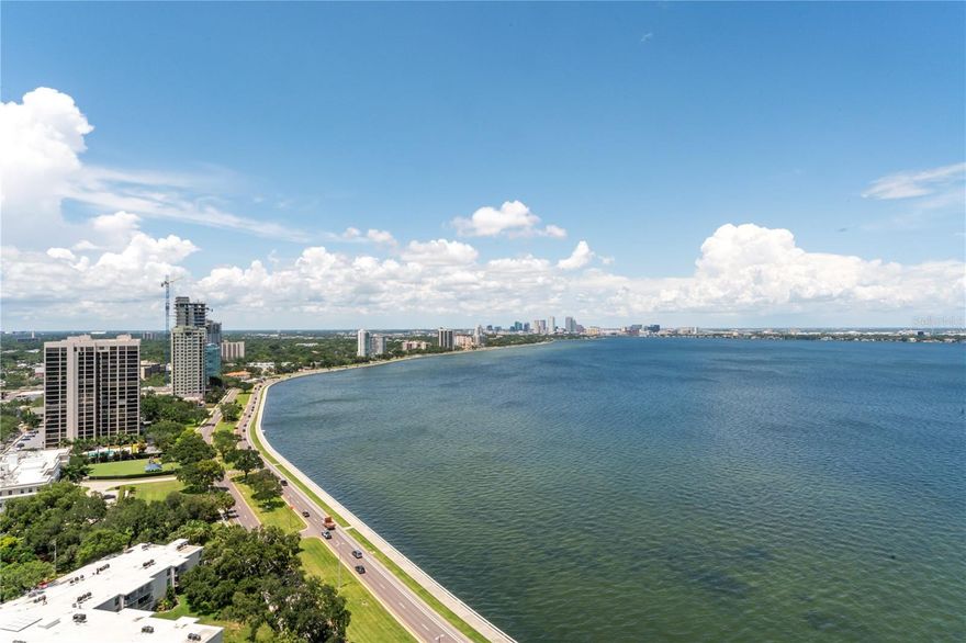 Very rare Bayshore facing Virage Estate Penthouse being offered for the first time since pre-construction sales. Live in the Premier building on Tampa's iconic Bayshore Blvd. This 22nd floor home has absolutely stunning water and downtown views. If you think the daytime views are breathtaking, the nighttime views are even better with the shimmering lights of Downtown Tampa sparkling over the bay. Park in the secure gated garage with your 2 spaces equipped for a car charger. The elevator opens into your own private foyer and as you step into the home and take in the majestic views, it’s like living on a yacht in the sky! The kitchen opens to the family room featuring a beautiful Holly Hunt light
fixture and both overlook the oversized front balcony with an abundance of space for relaxing or an al fresco dinner. The kitchen features a 48-inch Sub-Zero Refrigerator, Wolf Double Ovens, Wolf Induction Range (there is gas plumbed if you prefer it), and a Miele dishwasher. For the BBQ Chef this home also comes with a nearly impossible to find built-in gas grill located on the balcony. The kitchen island is oversized and has a ton of storage space with cabinetry on the front and back. Off the kitchen is the Butler’s Pantry with more storage which leads to
the formal dining room with a stunning Holly Hunt chandelier.  Behind the Dining Room is the Den with a custom-built entertainment center holding the TV, shelving, and cabinets. In addition, there is a custom-built bar area with a large Sub-Zero Wine Refrigerator. The split floor plan is optimal for privacy with the 3 guest suites situated at the rear of the home, all with water views, while the enormous Primary Bedroom is on the front corner overlooking the bay and with its own private balcony.  There are 2 very spacious custom-built closets and a gorgeous
Primary Bathroom with a soaking tub and an oversized walk-in shower.  Truly a magnificent home!