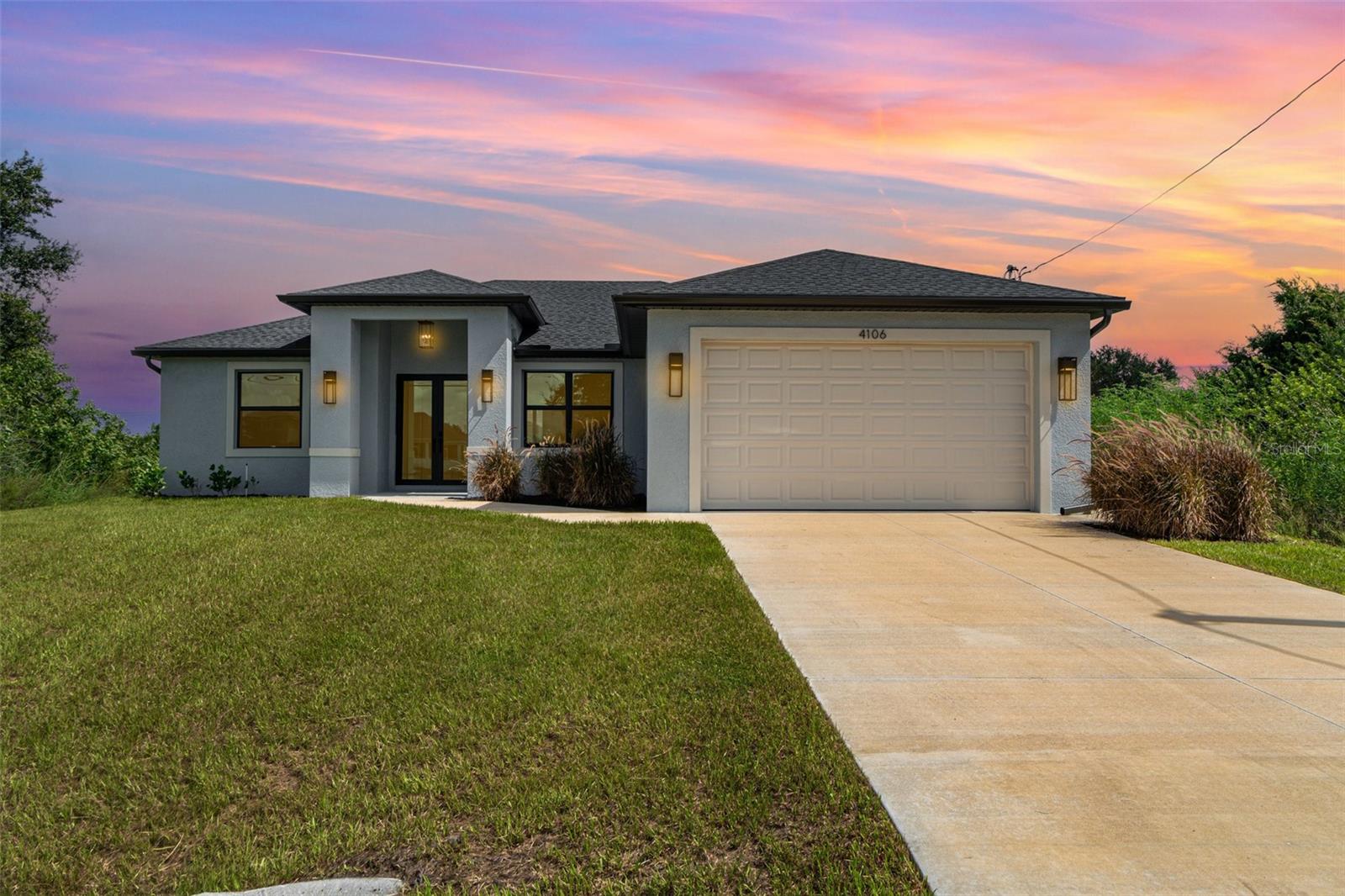 Welcome to your dream home, a brand-new construction in a prime central location in Lehigh Acres. This home offers a perfect mix of luxury, style, and convenience, built with exceptional quality and attention to detail. It's designed for modern living and peace of mind. This spacious 3-bedroom, 2-bathroom residence features a versatile den that's perfect for a home office or cozy reading nook. The split floor plan ensures privacy, with the luxurious primary suite tucked away on one side of the home. The primary suite is a true retreat, boasting an elegant tray ceiling and two spacious walk-in closets. In the spa-like primary bathroom, you can relax in a standalone soaking tub or enjoy the sleek, frameless shower. The bathroom also features two separate sinks and vanities, along with a private water closet. The heart of the home is the chef's kitchen, which features high-end GE brand stainless steel appliances, elegant quartz countertops, and soft-close cabinetry with a beautiful tiled backsplash. This space flows seamlessly into the large great room, making it ideal for entertaining. Throughout the home, you'll find 8-foot doors, decorative lighting and fans, and stunning large tile flooring. The living room also has a tray ceiling, adding an extra touch of sophistication. Beyond the stunning interior, you'll find top-of-the-line features for comfort and security. Hurricane impact windows and doors provide superior protection and energy efficiency. The exterior features a beautifully landscaped yard with lawn irrigation, which you can view from the screened-in lanai. The builder even added an integrated pest control system, allowing for easy access and a pest-free home. This fantastic location puts you close to everything you need. You're just a short drive from RSW International Airport, SR-82, and I-75, making travel a breeze. Enjoy the excitement of Spring Training for the Boston Red Sox and Minnesota Twins, or explore the area's excellent shopping and dining. When you're ready for a day in the sun, the beautiful Gulf Coast beaches are not far away. This home is more than just a place to live—it's a lifestyle. Come see what makes this brand-new home so special.