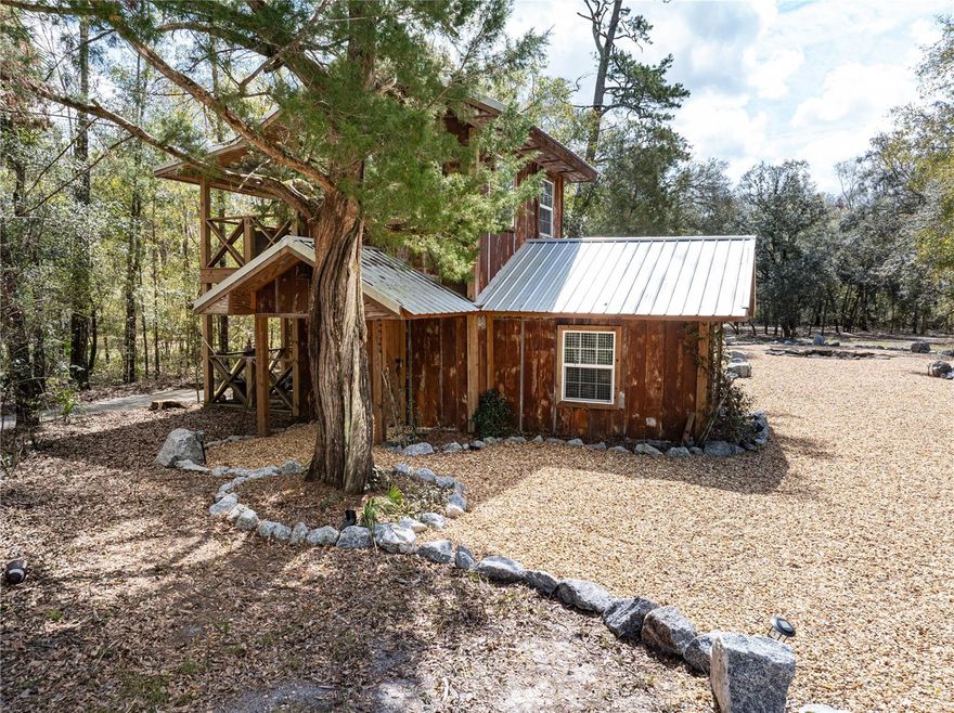 Discover 11.34 acres of breathtaking, historical Old Florida land, featuring 480 feet of prime riverfront along the Santa Fe River. This extraordinary property is a rare find, offering natural beauty, privacy, and endless recreational opportunities. Located just a short drive or boat ride from the Ichetucknee River, Ginnie Springs, and Blue Springs, for some of Florida's best swimming, tubing, diving, and kayaking. Just around the bend, the Suwannee River flows out to the Gulf. The property has been selectively cleared, creating open grassy areas beneath Granddaddy Oaks. The Santa Fe River is known for its many springs, including one nestled in the cypress head just off this property's beachfront. Plenty of high and dry land - build your dream home, recreational retreat, vacation rental or other development opportunities. Improvements include a 2 story cabin with HVAC, covered porches, septic, well, solar electric, diesel generator, fire pit, carport. Additional acreage available!