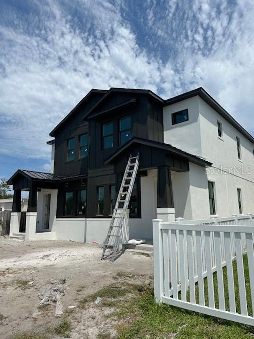 Under Construction. This beautifully designed townhome lives like a single-family residence with only one shared wall, a fenced yard, private balcony, covered front porch, and attached two-car garage. The open-concept floor plan is ideal for entertaining, featuring soaring 10’ ceilings, luxury vinyl flooring, modern lighting, and a spacious great room that flows seamlessly into the gourmet kitchen. The kitchen showcases 42” cabinetry, quartz countertops with waterfall island, designer tile backsplash, upgraded stainless steel appliances, and a walk-in pantry. Upstairs, the luxurious primary suite offers abundant natural light, dual closets, a tray ceiling, and a spa-inspired bath with double vanities, freestanding tub, walk-in shower, and private water closet. Additional highlights include impact-resistant windows and doors, ENERGY STAR appliances, high-efficiency HVAC, flush-mount LED lighting, and quality finishes throughout. This home also includes a 1-year workmanship and materials warranty, 2-year major mechanical systems warranty, and 10-year structural warranty for added peace of mind.