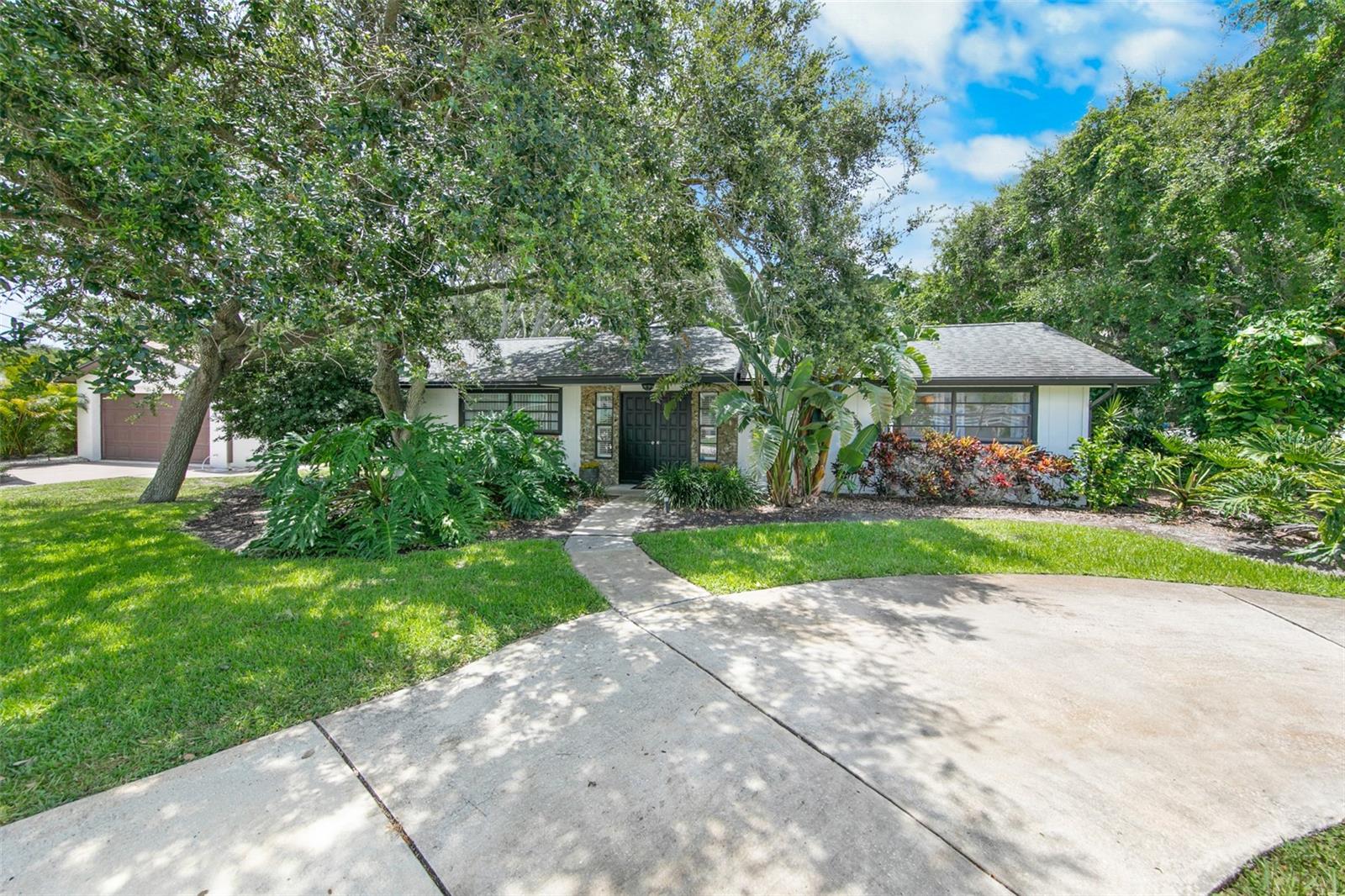 NEWLY REMODELED & UPDATED 3BR/2BA BEACHSIDE HOME LOCATED ON A PRIME CORNER LOT STEPS TO THE PRISTINE ''NO DRIVE'' BEACH IN SOUGHT AFTER PONCE INLET!! Step through the double door entryway into the welcoming foyer and your eyes focus on the tranquil beauty of the glass enclosed sun drenched atrium filled with natural light! This unique architectural feature creates a seamless connection between indoor comfort and nature's calming presence, making every moment feel refreshing and inspired. The spacious light & bright open floor plan boasts beautiful brand new wood look vinyl plank flooring throughout. A brand new HVAC system provides year round comfort and peace-of-mind. The comfortably large living room features decorative plantation shutters and overlooks the inviting outside patio with covered gazebo creating the perfect zen to relax while you hear the sounds of the surf and smell the salt air. The fully-equipped updated kitchen features Granite countertops, stainless steel appliances, a breakfast bar, large pantry, and ample cabinet space. Adjacent to the kitchen, the dining area offers the perfect setting for both casual meals and elegant gatherings. The primary suite has a large walk-in closet and sliding doors leading to the peaceful atrium, perfect for quiet mornings with a cup of coffee or serene evenings under the stars. Your friends/family will enjoy the en-suite guest bedroom with its own private full bathroom for added comfort and convenience. The third bedroom has dual pocket doors and is perfect for a third bedroom/office or den. Walk or bike to pickleball courts, basketball, tennis courts, playground, dog park & dog beach, Ponce Inlet Lighthouse and Jetty Park, seaside dining, the Marine Science Center, marinas, charter fishing, kayaking, and more. In one of the most sought after locations on the east coast, this home makes a great primary residence, second home or investment property. Flood zone X - no flood insurance required. The circular driveway, additional driveway, and one-car garage provide ample parking space. Enjoy Florida coastal living at its finest!!