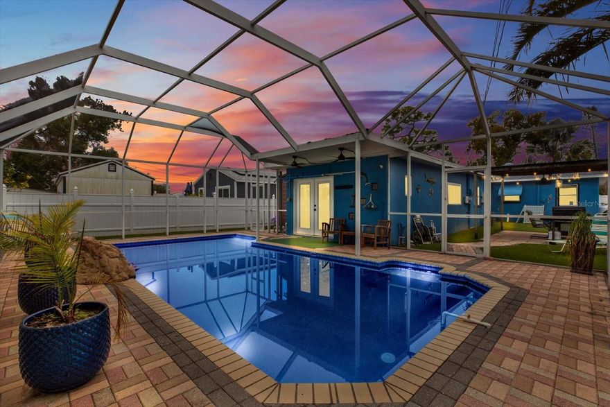 This POOL home in Gulfport checks all the boxes! This 3 bedroom, 2 bathroom solid block home, located in a NON-FLOOD ZONE, offers a paver driveway and walkways, custom awnings, mature landscaping, a 1-car carport (ideal for boat or RV parking), and a 2-car tandem garage with additional storage. Inside, you’ll find a bright living room with built-ins and an updated kitchen featuring stainless steel appliances, propane range, reverse osmosis system, breakfast bar, and plenty of cabinet space. Two guest bedrooms and an updated guest bath with jetted tub are located toward the front of the home. A dedicated dining room with triple sliders opens to the covered patio. Just beyond is a bonus room with indoor washer and dryer and additional flex space. The oversized primary suite is situated at the rear of the home and includes two large closets (one walk-in), an en-suite bath with walk-in shower, and French doors opening to your private backyard oasis. Pool features include a dark pebble finish, waterfall, newer UV-protective screened enclosure, newly installed chlorinator attached to the pool pump for ease and convenience, and new pool lighting with multiple settings and colors. Vinyl fencing and artificial turf create a low-maintenance, fully enclosed space, while an outdoor pergola provides the perfect spot for dining or entertaining. Additional upgrades include fully upgraded plumbing using a trenchless pipe-sleeving method with a lifetime guarantee, tankless propane water heater, newer roof and HVAC, double-pane windows, and SMART HOME features with WIFI and Bluetooth control of the range, dishwasher, lighting, washer & dryer, thermostat, front door, and pool pump. Just minutes from Downtown Gulfport's waterfront including many shops and restaurants, and close to Stetson Law School, an excellent location with income-producing potential.