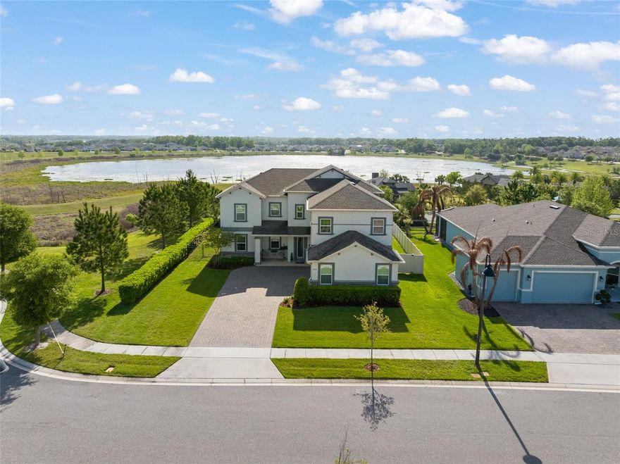 Welcome home to this exclusive Wekiva floor plan offering 5 bedrooms, 3 bathrooms, and a spacious bonus room, all perfectly positioned on a premium corner homesite at the top of a hill. Enjoy breathtaking, elevated views along with a beautifully designed backyard featuring a large pool—creating the perfect setting for both relaxation and entertaining. From the moment you arrive, the home impresses with its courtyard-style driveway and 3-car garage. Inside, a stunning glass entry door welcomes you into a thoughtfully designed open-concept layout that seamlessly connects the great room, dining room, kitchen, and casual dining area. Natural light fills the home, enhancing the bright and airy feel throughout. The gourmet kitchen is both elegant and functional, showcasing ivory cabinetry, gorgeous quartz countertops, a large center island, ample prep space, and a generous pantry. The adjacent casual dining area provides direct access to the covered lanai through sliding glass doors, creating effortless indoor-outdoor living. The primary suite is a true retreat, featuring a spacious sitting area, large walk-in closet, dual vanities, a soaking tub, and a separate walk-in shower. A versatile bonus room with double door entry offers the perfect space for a home office, media room, or additional living area. Step outside to your private backyard oasis, where the expansive pool and elevated homesite combine to offer beautiful views and a sense of privacy rarely found. Whether hosting gatherings or enjoying a quiet evening, this outdoor space is truly special. Additional features include energy-efficient construction, included appliances, and quartz countertops throughout. Located in Arden Park, a community known for its timeless architecture, mature oak trees, and scenic conservation areas, residents enjoy access to parks, a community pool, cabana, and direct proximity to the West Orange Trail. This prime Ocoee location offers the perfect blend of natural beauty, modern convenience, and an exceptional lifestyle.