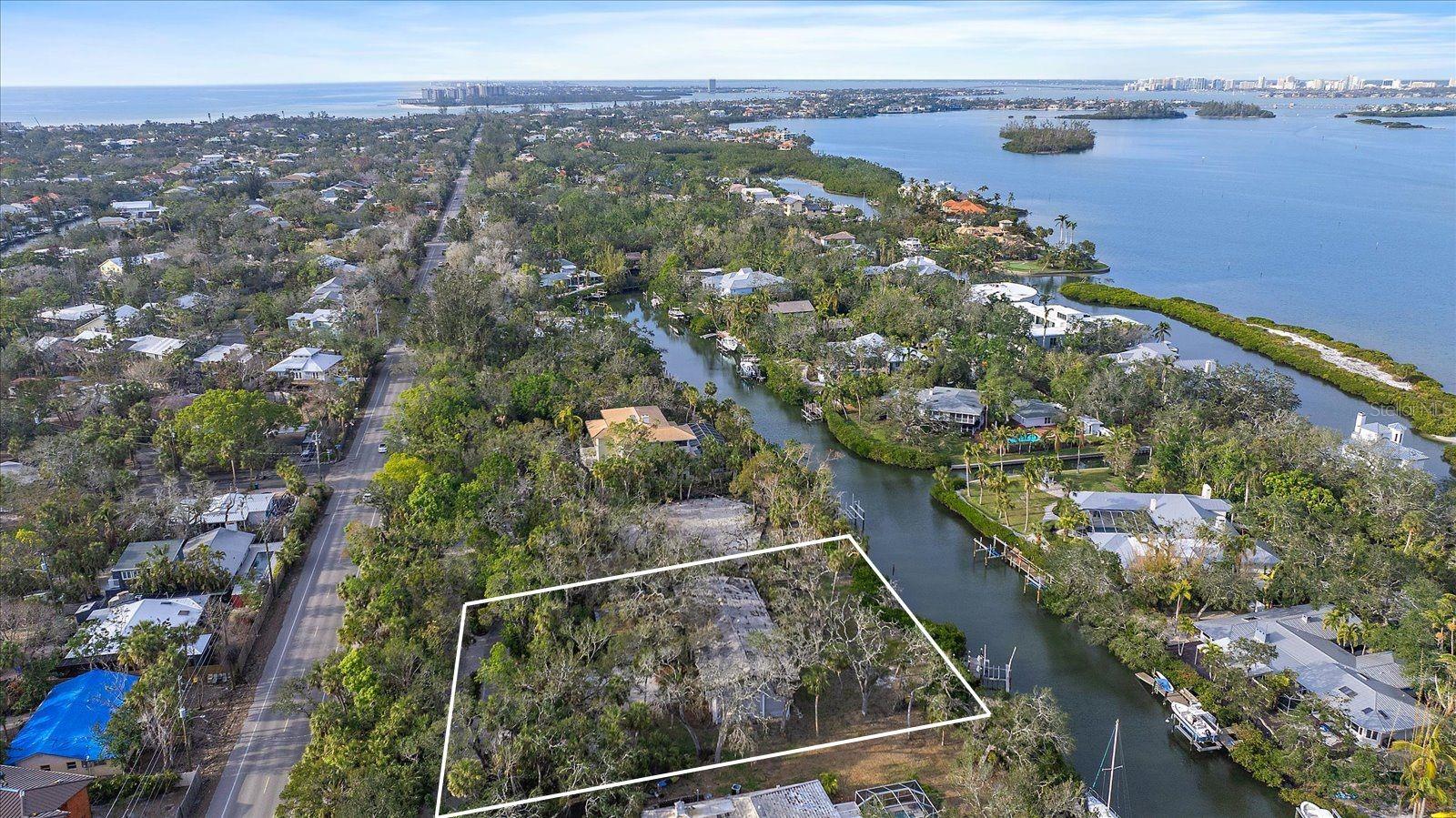 An exclusive opportunity awaits on Siesta Key—a .6-acre homesite in the prestigious Hidden Harbor community. With 144 feet of prime canal frontage, this property offers direct access to the sparkling waters of Sarasota Bay, making it a boater’s paradise. As you arrive, a tree-canopied, pavered street winds through a secluded enclave of luxurious estate homes, setting the stage for the ultimate waterfront retreat. This is a rare chance to build your dream home in one of the island’s most coveted neighborhoods. The existing structure sustained flood damage from recent hurricanes and is being offered at lot value only—an incredible opportunity to create a custom masterpiece in this serene, private setting. Opportunities like this are few and far between—secure your slice of Siesta Key paradise today.