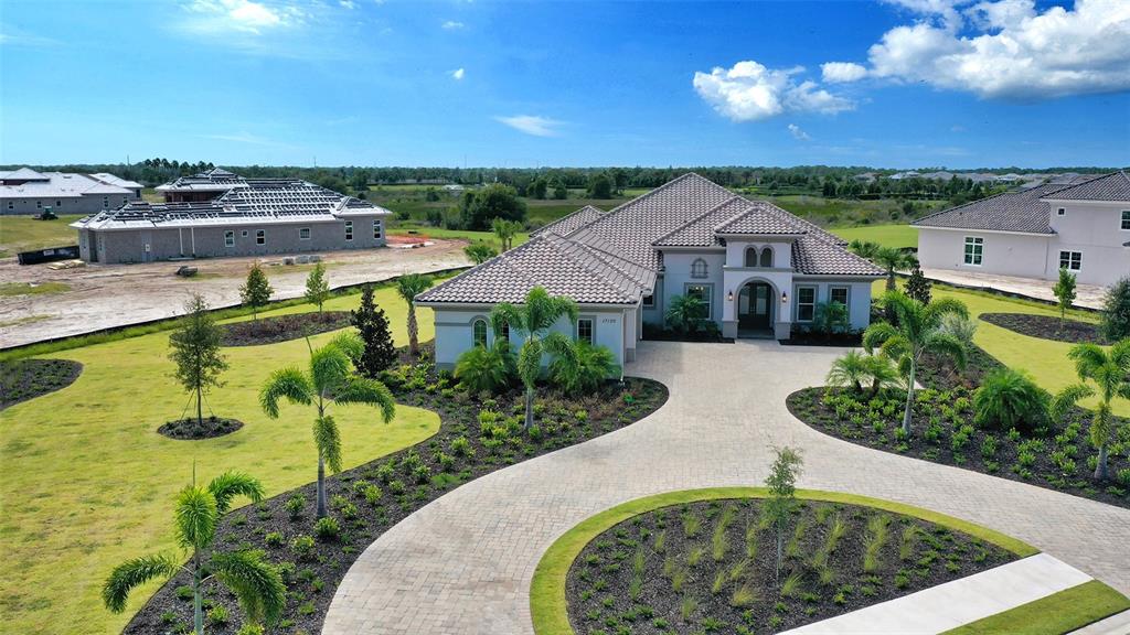 Welcome to this beautiful custom Sterling model from Stock Signature Homes this home was specifically crafted with some unique features and upgrades that make it a one of a kind home. Structurally the home was upgraded with the addition of an extra large Bonus Room, Enlarged Master Bedroom Suite, Disappearing Corner Sliders at the Breakfast Nook, 10Ft. Sliding Glass Doors in all rooms ,Upgraded Ceiling Heights, Central Vaccum and Remote Blinds in all rooms. The Sterling model offers 3 Bedrooms/ 4 Full Baths and has an additional room that is set up as an exercise room but can easily converted into a 4th Bedroom. There is a generous sized Study with glass french doors and formal dining room where family and friends can gather for get togethers. The Gourmet kitchen is a chefs dream with extra large kitchen island dressed out in upgraded granite countertops and raised wood cabinets throughout. Outdoor living on this home is taken to a new level with a generous sized outdoor living area perfect for grilling and chilling or entertaining. Speaking of Generous this gorgeous home sits on one of the largest lots within the lake club and is just under 1 acre with a beautiful preserve view as the backdrop. The Lake Club offers incredible amenities and services including two resort style heated pools, a recently renovated clubhouse offering fine dining and entertainment, a fitness center, spa, har-tru tennis courts, pickle ball, playground, dog park and a full-time concierge and activities director. Make it point to come and see this one of a kind home! You will be glad you did! Room Feature: Linen Closet In Bath (Primary Bedroom).