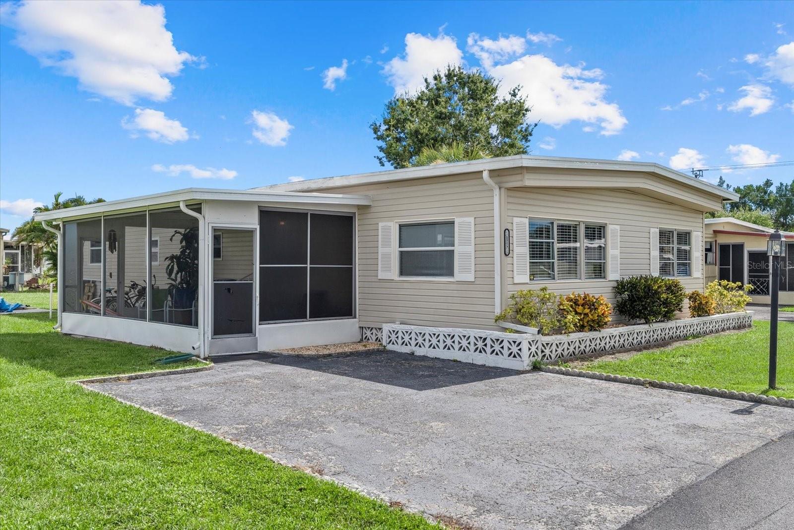 HONEY STOP THE CAR - THIS IS THE ONE! SELLING WAY under APPRAISAL AMOUNT!! One of the BEST in the park!! Step into one of the LARGEST square footage units in the park. This fully furnished and tastefully remodeled DOUBLEWIDE mobile home, where designer style meets builder-quality craftsmanship. Rebuilt from the ground up, this home is truly move-in ready—completely furnished down to the dishes, so you can unpack and start enjoying immediately. The majority of the home features gorgeous new flooring, adding warmth and style throughout. The open-concept floor plan where the kitchen is designed for entertaining, complete with a spacious island, a breakfast bar and two dining areas, stainless steel appliances, a pantry, and a dishwasher. The home also includes the convenience of indoor laundry with a washer and dryer already in place and a brand new water heater installed this month. All bedrooms are generously sized, and the third bedroom offers flexibility—perfect as a guest room, office, or hobby space with the simple addition of a wardrobe. Enjoy Florida living from the lovely screened-in lanai, ideal for relaxing with a breeze. Located on a large corner lot, the home offers great curb appeal, a welcoming driveway, and a poured concrete pad ready for a storage shed if desired. Pets are welcome, and the low monthly fee covers essentials such as high-speed cable and internet, water, sewer, garbage, recycling, and lawn maintenance. This vibrant community offers impressive amenities, including a 110,000-gallon heated pool, a 4,000 sq. ft. clubhouse, social events, bingo, crafts, card games, horseshoes, shuffleboard, billiards, potluck dinners, coffee hours, ladies’ luncheons, RV and boat storage, and even a library. Located just minutes from world-renowned Gulf beaches, this home offers an affordable oasis with an unbeatable lifestyle.