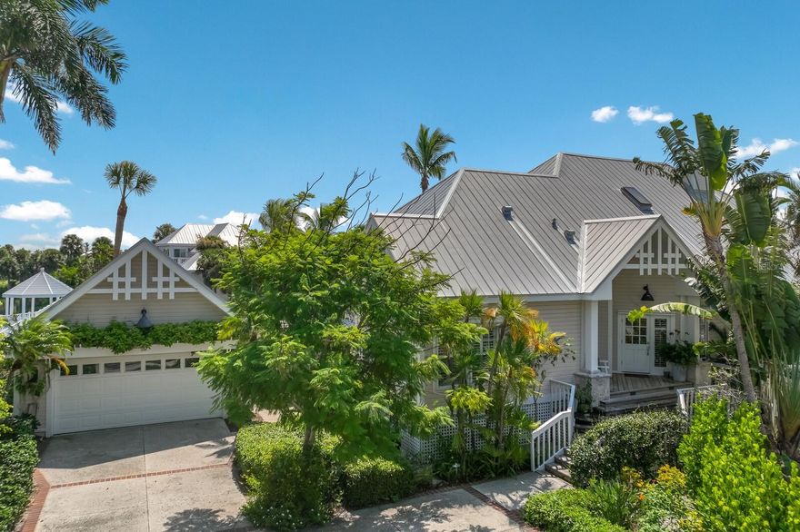 Welcome to 150 Carrick Bend Lane, a stunning lakefront cottage nestled in the North Village neighborhood of the Boca Bay Community. This delightful house is situated on a rarely available large corner lot, offering both privacy and convenience. Boasting an expanded Alamanda floor plan, this spacious home encompasses 3 bedrooms, each with its own en-suite bathroom, providing privacy and convenience for all residents. The complete renovation in 2015 ensures this home provides updated modern amenities while maintaining its classic charm. As you step inside, you'll be greeted by wide plank hardwood flooring that exudes warmth and sophistication. The living room features custom built-in cabinetry, exposed beams, a vaulted ceiling, and retractable sliding doors that open to a screened porch creating an inviting ambiance overlooking the lake perfect for relaxation or entertaining guests. Enjoy the dining room that opens to an additional screened porch for outdoor dining with a custom wet bar to serve your favorite libations to guests. The large gourmet kitchen is a chef's dream come true, complete with a vaulted/beamed ceiling, solid surface counter tops, custom lighting, glass front cabinetry, a center island with prep sink, top of the line subzero refrigerator, oversized recessed porcelain farm sink and a charming keeping room where family and friends can gather. Prepare delicious meals with ease while enjoying the beautiful views from the wall of windows. As you explore further, you'll discover the second floor offers a large master bedroom with a private balcony and a landing area that can be transformed into a cozy reading nook or study space. Additional features include plantation shutters, designer wallpaper, custom chandeliers, skylights in the master bathroom, a metal roof installed 2011, a large lakeside deck for grilling or star gazing, and an outdoor shower. Situated on a prime corner lot, this property offers not only ample parking with a separate detached garage but also stunning views of the preserve that will leave you in awe. Imagine waking up to the tranquil sight of the water every morning. With the mature landscaping and 188 feet of lake frontage, whether you're sipping your morning coffee or hosting a barbecue, the multiple outdoor living areas are perfect for enjoying Florida's year-round beautiful weather. Convenience is at your doorstep as this incredible home is just a short walk away from both the beaches of the Gulf of Mexico and the quaint shops and restaurants in the Village of Boca Grande. Embrace the laid-back lifestyle that awaits you in this wonderful amenity rich community that includes a membership to the Boca Bay Pass Club that includes a beach front grill room, private formal dining room and a casual pool side bar, 4 community swimming pools, an active tennis program with tennis pros, pro shop and 8 Har-Tru courts, additional courts for pickle ball, a fishing pier, and boat slips for short term dock-age.  Don't miss out on this extraordinary opportunity to own a slice of paradise. Schedule a viewing today and let 150 Carrick Bend Lane become your dream home.