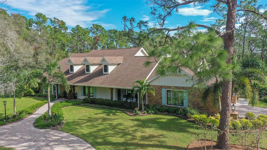 Beautiful home perfectly nestled on 5.75 acres in the private community of Gator Creek Estates. Gator Creek properties rarely come available as homes with acreage so close to all services and the city of Sarasota are a sought-after commodity. This home has been tastefully updated with a casual and comfortable floor plan that's perfect for the family and entertaining. Spacious room sizes and the bonus of a second master suite that opens onto the lanai and lovely covered living area, pool and scenic backyard. Perfect for visiting parents, guests, or adult children. Some of the recent improvements include new PGT impact windows & Therma-Tru impact doors, plantation shutters, engineered hardwood flooring, custom oak staircase, Bosch appliances, LED lighting, interior/exterior paint, exterior composite shutters, well equipment, outdoor grill area, pool heater, pond fountain, irrigation, landscape lighting, resurfaced saltwater pool, huge outdoor Trex deck and more. Roof is 9 years old and septic tank is 5 years old. Long meandering driveway from the road provides plenty of privacy with a circular drive and an additional garage provides for a total of 4 cars under cover. Wood burning fireplaces in the family room and another on the lanai. The exterior of this home is just as fantastic as the interior. The outdoor fireplace is the perfect backdrop for those cool winter evenings with a nip in the air and a fire to warm the toes. Huge brand new Trex deck has plenty of space for an outdoor eating and lounge area. Perfect space for family gatherings or hosting a party. The screened pool area also has ample deck space to stretch out and sun at the pool, enjoy having a meal or getting under cover to watch the big screen TV with refreshments in front of the fireplace. You have a beautiful backdrop of a manicured landscape with large pond and fountain with interchangeable colors. This comfortable well cared for home along with the private and serene setting is a special place you'll love calling home.