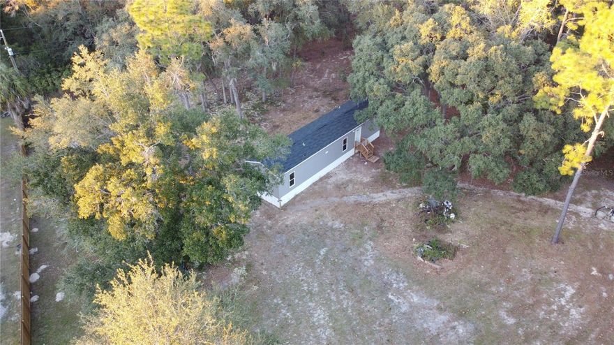 Brand New 2/2 MH on almost an acre in the sought after quiet community of Morriston. This fenced & gated manicured property is canopied with granddaddy oaks. Includes a new well, septic, HVAC and all new appliances! Well maintained entrance just off the main road (S.R. 121) and a short drive to major cities (Ocala and Gainesville). High & Dry, NO HOA or CDD! Call today to make this slice of Florida your own!