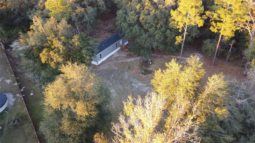 Brand New 2/2 MH on just under an acre in the sought after quiet community of Morriston. This gorgeous fenced & gated property is canopied with granddaddy oaks & features a well maintained entrance just off the main road (State Road 121). NEW well, septic, and AC all installed this year! High & Dry, NO HOA or CDD!