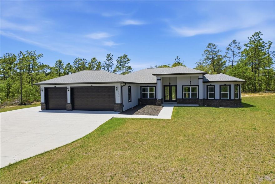 NO NEED TO WAIT ON CONSTRUCTION! THIS NEVER LIVED IN 2025 HOME IN PINE RIDGE HAS SPACE TO SPREAD OUT, MODERN STYLE, AND TRULY STANDS APART! Step into this stunning 2025 custom-built 3 bedroom (plus office), 3 bath, 3 car garage home in Pine Ridge where every detail feels intentional from the moment you arrive. The stacked stone pillars and grand double door entry welcome you into a bright, open floor plan with soaring tray ceilings and beautiful luxury vinyl plank flooring throughout. The living room is spacious and inviting, complete with a custom built-ins for your entertainment center, and flows seamlessly into a show-stopping kitchen featuring white cabinetry, a massive curved island with dark countertops, double built-in ovens, a gas cooktop with a sleek stainless range hood, modern statement lighting, and huge pantry. Natural light fills the home, including a beautiful dining nook surrounded by windows overlooking your private, tree-lined lot. This 3 bedroom (plus office), 3 bathroom split floor plan offers a true retreat in the oversized primary suite with tray ceilings, dual walk-in closets, and a spa-like bathroom featuring double vanities and an elongated walk-in shower with upscale finishes. Even the laundry room is thoughtfully designed with built-in cabinetry, workspace, and a utility sink. A dedicated pool bath is already in place, making it easy to create your future backyard oasis, while the oversized 3-car garage, extended driveway, and expanded concrete pad add both convenience and durability. High and dry, no flood insurance required. Located in the highly sought-after Pine Ridge community of Citrus County, residents enjoy 28 miles of equestrian trails, stables, riding areas, tennis courts, and a community center. Zoned for Central Ridge Elementary School, Citrus Springs Middle School, and Lecanto High School. Conveniently located with easy access to both Citrus and Marion Counties and the Suncoast Toll Road ramp is just outside the entrance to Pine Ridge, so you can be to the Tampa Airport in just over an hour! This property offers the perfect balance of privacy, recreation, and accessibility, all within Florida’s beautiful Nature Coast. Don't let this one get by!