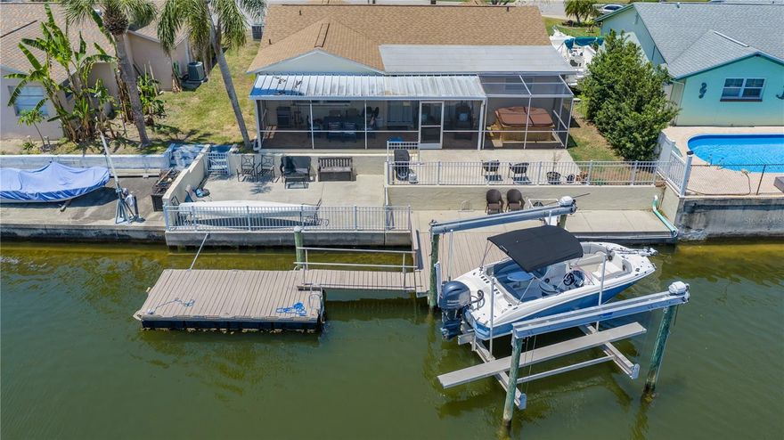 Welcome to your own slice of WATERFRONT PARADISE with DIRECT GULF ACCESS in the highly sought-after SEA PINES COMMUNITY of HUDSON, FLORIDA! This beautifully maintained 2 BEDROOM + FLEX SPACE, 2 BATHROOM, 1 CAR GARAGE HOME with a BOAT LIFT is perfectly positioned on a quiet CUL-DE-SAC just TWO STREETS FROM THE GULF, offering the ideal blend of coastal lifestyle, comfort, and convenience in a GOLF CART FRIENDLY NEIGHBORHOOD.
From the moment you arrive, you’ll notice the EXTENDED DRIVEWAY, charming front porch, and decorative glass entry door. Inside, the home features a desirable OPEN FLOOR PLAN filled with natural light and designed to capture STUNNING WATER VIEWS from multiple living areas.
The main living spaces feature TILE FLOORING THROUGHOUT, while both bedrooms offer durable VINYL FLOORING. The kitchen is a standout with GRANITE COUNTERTOPS, STAINLESS STEEL APPLIANCES, DOUBLE OVEN RANGE, PANTRY CLOSET, VAULTED CEILINGS, and stylish wood accents. The EAT-IN KITCHEN AND DINING AREA OVERLOOK THE WATER, and flow seamlessly into the family room—perfect for entertaining.
The spacious primary suite offers a private retreat with an UPDATED PRIMARY BATHROOM featuring a FLOOR-TO-CEILING SUBWAY TILE WALK-IN SHOWER, CUSTOM GLASS DOORS, and built-in shelving for a spa-like feel. The guest bedroom is generously sized, and the guest bathroom is also updated with a CUSTOM SUBWAY TILE SHOWER/TUB COMBINATION, providing a clean, modern finish throughout.
A versatile FLEX SPACE adds incredible value—ideal for a home office, den, second living area, or hobby room.
Step outside to your WATERFRONT BACKYARD OASIS featuring DIRECT GULF ACCESS, an oversized BOAT LIFT, FISH CLEANING STATION, and TWO DOCKS (FLOATING + STATIONARY)—perfect for boating, fishing, kayaking, and enjoying the ultimate Florida lifestyle. The expansive SCREENED-IN LANAI spans the back of the home and includes a HOT TUB, PAVER FLOORING, and peaceful water views, creating the perfect space to relax or entertain year-round. Additional features include WROUGHT IRON FENCING, multiple concrete deck areas, and ample outdoor living space. Additional updates include double pane windows, Roof in 2022 AC in 2025 and Hot Water Heater in 2023.
SEA PINES offers true coastal living with easy access to boating, waterfront dining, marinas, and unforgettable sunsets right from your backyard. Conveniently located near shopping, restaurants, beaches, hospitals, and the SUNCOAST PARKWAY for an easy commute to Tampa.
Whether you're searching for a FULL-TIME RESIDENCE, VACATION HOME, or INVESTMENT PROPERTY, this exceptional waterfront home checks all the boxes.