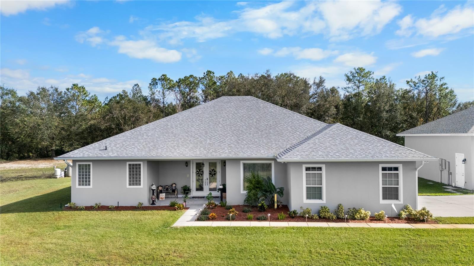 Welcome to Paradise Country Estates!
Tucked away in this lovely community in a beautiful country setting sits a Gorgeous 3 Bedroom 2.5 Bath split plan home with an office and 2 car garage with an additional HUGE 2 Bay Shop for all your toys, and let's not forget, NO HOA!
This spacious home offers nearly 2,600 sq ft of living space and sits on 6.37 acres. The back acreage is still wooded allowing the deer to roam. The possibility with the wooded acreage is unlimited, create walking trails, bike trails, sitting areas, let your imagination run wild!
There’s plenty of open space for Entertaining both indoors and outdoors with a 18x31 screened in Lanai with beautiful glass pocket sliders that create a huge space for mingling with your guests.
Wait till you see this amazing kitchen with leaded glass cabinets! Offering tons of storage, a walk-in pantry and plenty of counter space for preparing all your favorite dishes. Guys, the huge 36x31 detached garage is just for you. It has room for your Boat, equipment, all your play toys and RV parking, just what you need!!!
Here are some of the updates that you can enjoy with your New Home:
New Tankless Water Heater - 2017
New 15 seer Heat Pump (air handler & condenser) April 2020
New Roof on House and Shop in 2021.
New submersible pump Nov 2022
Gutters added in 2022
Irrigation added in front - 2023
Septic Tank Pumped - Oct 2024
Schedule Your Showing Quickly Before this rare hidden gem is snatched up!