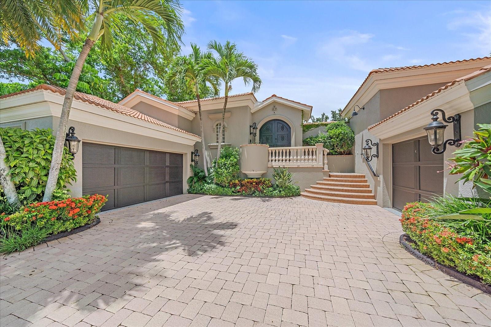 This one-of-a-kind, fully renovated residence is nestled in the heart of Sarasota’s historic McClellan Park—just steps from the bayfront, downtown, and Southside Village. Originally built by a well-known builder as his personal home and reimagined in 2022 by the previous owner, an interior designer, the property showcases timeless elegance, custom finishes, and exceptional privacy. Beyond hand-forged iron gates lies a tranquil travertine courtyard with a heated pool, cascading spa, bistro lighting, full outdoor kitchen, and a detached guest suite. Inside, the main home offers a chef’s kitchen with top-of-the-line Miele appliances, custom cabinetry, and stone countertops, along with spacious living and dining areas featuring marble floors, coffered ceilings, and expansive pocket sliders for seamless indoor-outdoor living. The luxurious primary suite includes French doors to a private balcony, designer touches throughout, dual walk-in closets, and a spa-like Carrera marble bath with soaking tub and walk-in shower. Recent upgrades in 2024 include a brand-new AC system, whole-house water softener, and all new light fixtures. Additional highlights include a private library or office, 3-car garage, Lutron lighting system, Sonos audio, security cameras, handicap-accessible entry, and lush, low-maintenance landscaping.