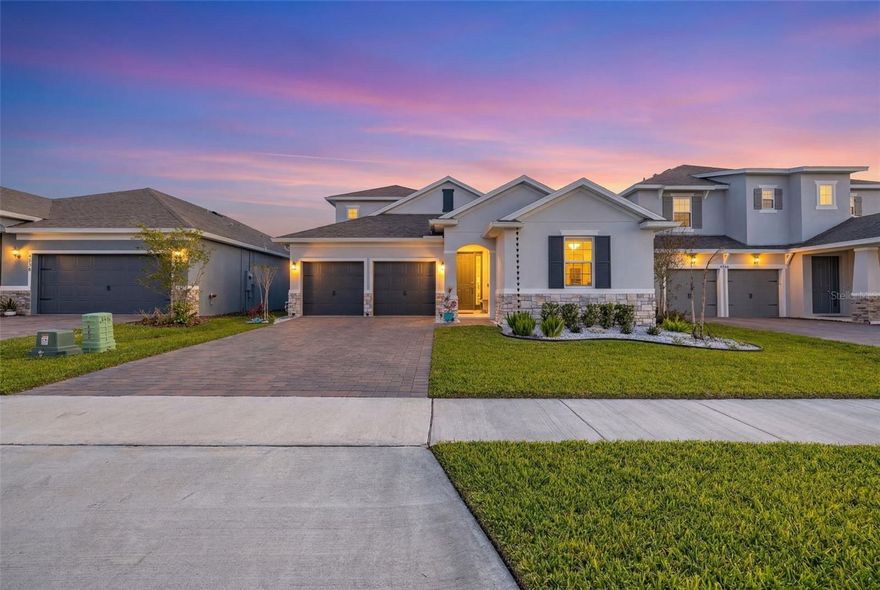 Welcome to Hartwood Landing, one of Clermont’s most sought-after communities! This exceptionally maintained home offers high-quality finishes, a private covered lanai, and a fully fenced backyard - perfect for relaxing or entertaining. The open split floor plan features elevated ceilings, a sophisticated designer color palette, and modern wood-look laminate flooring with raised baseboards throughout the main living areas. The desirable ground-floor owner’s suite provides privacy and comfort, while the spacious loft with a full bathroom, extra-large storage closet, and laminate staircase offers flexibility for a home office, play area, or guest space. Beautiful 8’ tall interior doors enhance the home’s elegant feel.Fall in love with the stunning gourmet kitchen, complete with quartz countertops, 42” wood cabinets with upgraded hardware, built-in wall oven and microwave, ceramic glass cooktop with stainless steel vent hood, built-in refrigerator cabinet, decorative backsplash, roomy walk-in pantry, and an expansive kitchen island - perfect for entertaining family and friends.The upgraded laundry room is a showpiece of its own, featuring custom butcher block countertops, built-in cabinetry, and a striking tiled accent wall extending to the ceiling. Additional thoughtful upgrades include ceiling fans and blinds throughout, an electric car 50AMP charger in the garage, and a decked attic with pull-down ladder.The deluxe owner’s suite boasts two separate walk-in closets (one with custom built-ins) and a spa-like bathroom with double sinks, quartz countertops, a large frameless shower with rainfall showerhead, premium wall-to-ceiling tile work and matte black plumbing fixtures. Three additional guest bedrooms are conveniently located on the first floor. Outside, the home shines with upscale stone accents, a vinyl fence, added gutters, enhanced landscaping with decorative rocks, a paved driveway, and a discreet garbage enclosure. The HOA fee is reasonable, covering internet, common grounds maintenance, and access to the community pool - with no CDD! Located in rapidly growing Clermont, this home offers easy access to area restaurants, shopping, major roads, Downtown Orlando, Orlando International Airport, world-famous theme parks, and Florida’s beautiful beaches. Hartwood Landing provides the perfect combination of style, comfort, and convenience. Don’t miss the opportunity to make this exceptional home your own - schedule a private showing today!