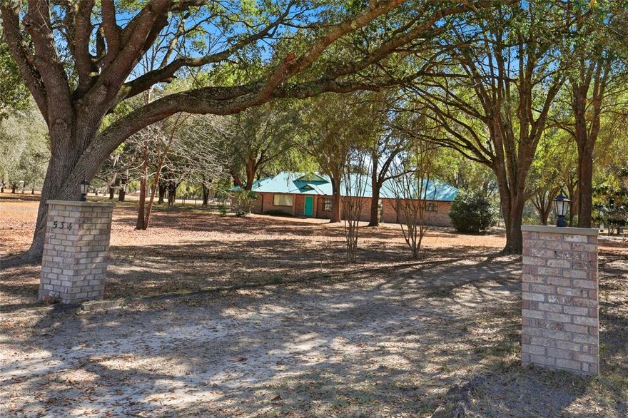 One or more photo(s) has been virtually staged. Only a short and scenic drive northwest from Gainesville, FL., and just across the Alachua County line into Columbia County, discover Santa Fe River Plantations.  Right in the heart of "springs country", this peaceful community provides privacy and serenity. Enjoy the easy access to a world of outdoor recreation opportunities in the immediate area, including kayaking, fishing, tubing and paddling on the local Santa Fe and Ichetucknee rivers, swimming and diving in the numerous natural springs including Poe, Ginnie, and Blue Springs, horseback riding and more. Or spend time discovering the charming towns of High Springs and Alachua which are located only minutes away, offering many shopping and dining opportunities This lovely and sturdy all brick one owner home sits on a private and spacious 1.5 acre property, with mature live oak trees and cleared areas to enjoy.The covered back porch provides plenty of space for entertaining and relaxation, and overlooks the back yard which is completely fenced, perfect for pets and children. As you step inside this open and airy home, you will notice the light filled space, with light streaming in through the two picture windows in the great room. This 3 bedroom, 2 full bath home was thoughtfully designed for comfort and privacy with a split bedroom floorpan. Also included is an open kitchen with breakfast bar, ample cabinet storage and built in pantry, a great room space with vaulted ceilings and gas fireplace, a recreation/ dining/media space, a separate dining room, and indoor laundry room. All luxury vinyl plank flooring and ceramic tile flooring throughout the home for easy maintenance. Two car side entry garage offers a workbench and attic storage access. The enclosed storage shed provides room for yard equipment and more. Take advantage of the lower property taxes in Columbia County, and enjoy all this area has to offer. See updated square footage from building plans.