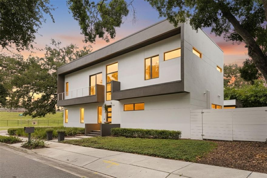 This stunning residence stands just steps from the highly coveted Waverly Park Circle. It’s distinguished by its exceptional quality and modern architecture. Thanks to TWO STORY BLOCK construction, sand-smooth stucco, and impact-resistant windows and doors, the home is not only visually stunning but also meticulously crafted but virtually SOUND PROOF! Built as a personal residence by the architect and builder of custom homes, Domain Development (D2), every detail has been artfully selected.  Designed with gatherings in mind, the home features a formal dining room with a custom table for fabulous dinner parties and a spacious family room perfect for fun holiday celebrations. When the festivities move outside, sliding open the wall of glass doors transforms the indoor living space into an outdoor sanctuary. Guests can enjoy the saltwater pool and spa, gather at the bar beside the fully equipped outdoor kitchen, or relax by the fire in the outdoor living area. Alfresco dining is easily accommodated with a dedicated table. Back inside, the kitchen will impress even the most discerning chef. Features include a Jenn air gas cooktop, dual built-in ovens, a Subzero refrigerator, and large island with extra storage and seating. The sleek, modern design of the custom cabinets and counters is easy to maintain, thanks to the walk-in working pantry with appliance counter and shelving. Other benefits to the home include a downstairs primary bedroom suite with two walk-in closets. The bathroom features a floating dual sink vanity and walk-in shower. A private study and powder bath complete the first floor. Upstairs, find a reading loft flush with an abundance of natural light. There are four additional secondary bedrooms and three bathrooms. Additionally, there is an expansive laundry and bonus room. Additional highlights include a temperature-controlled wine room with space for 333 bottles, a mudroom with plumbing for a future bath, an oversized two-car garage, and pre-wiring for a generator. Convenient to downtown Tampa, Bayshore, and A rated schools. Also, it's in an X FLOOD ZONE with NO FLOOD INSURANCE requirements. The only challenge with buying this remarkable home is deciding how best to enjoy all it has to offer! Schedule your showing today!
