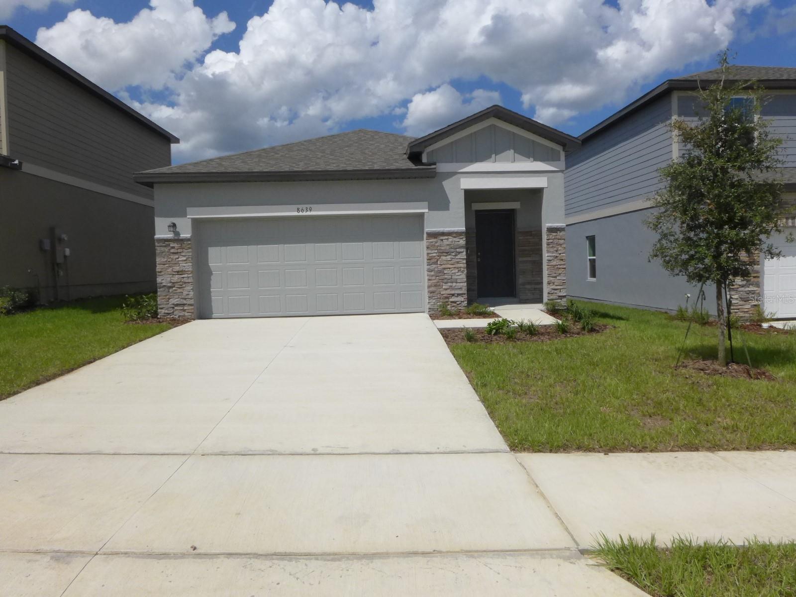This nearly new 3-bedroom, 2-bath home features an open floor plan, a spacious kitchen with granite counters, and a 2-car garage. Located in Groveland's Phillips Landing neighborhood, it offers stunning scenery and excellent amenities. Situated in Lake County, it's northwest of Orlando near Clermont, just a half-hour drive to the theme parks. The home is 2 minutes from the Florida Turnpike entrance, minutes from main highways, restaurants, and shopping in Clermont, and only 3 minutes north on US 27 to the Orlando Health facility.