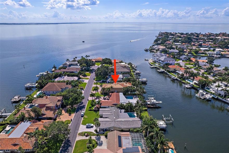 Here's your opportunity to put your personal touch on this magnificent two-story WATERFRONT residence located at 2250 Mermaid Point NE in the esteemed Venetian Isles of St. Petersburg, FL. This 4 bedrooms/4 bathrooms home boasts 3,572ft² of  air conditioned living space, also featuring: a backyard oasis with POOL and COVERED entertaining area, NEWER DOCK and SEAWALL (2017), a NEWER clay tile ROOF with 35+ years of life remaining (installed in 2013), ELEVATOR, full house GENERATOR, and a 3-CAR garage, all sitting on a spacious 12,158 square foot lot.

As you step inside, you'll be greeted by captivating water views. The main floor hosts 3 bedrooms and 3 bathrooms - ALL with EN SUITE bathrooms. The 2 story open living room offers views and sliding glass doors to the backyard patio, pool and canal. The MASSIVE primary suite resides on the ENTIRE second floor, easily accessible via the convenient elevator. This upper level suite has an incorporated office area, walk in closet, en suite bathroom featuring a garden tub with separate walk in shower, and separate double vanities. The newer seawall and dock (2017) provide seamless access to one of the largest canals in Venetian Isles, allowing for effortless boating excursions to the glistening waters of Tampa Bay.

Outside, a sprawling private yard with a variety of outdoor spaces, including a vast paved, covered back porch that's perfect for basking in the Florida sunshine is complimented by a large heated pool.

This Mermaid Pointe Oasis offers an unparalleled opportunity for waterfront living and lavish entertaining. All that's missing is your personal touch. Don't miss the chance to make this stunning waterfront retreat your own.
